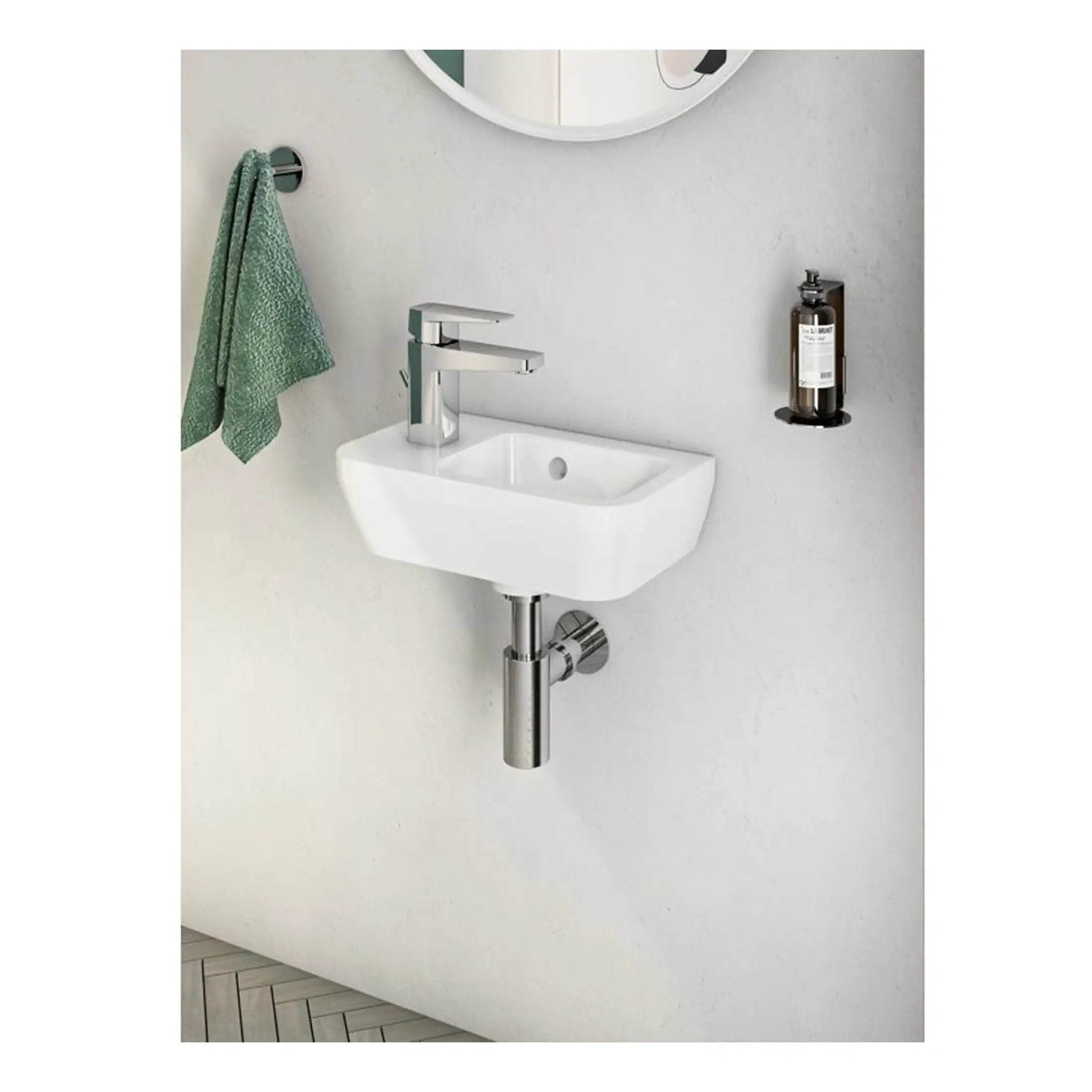 Modern white bathroom sink with chrome tap and wall-mounted soap dispenser, minimalist design perfect for contemporary bathrooms.