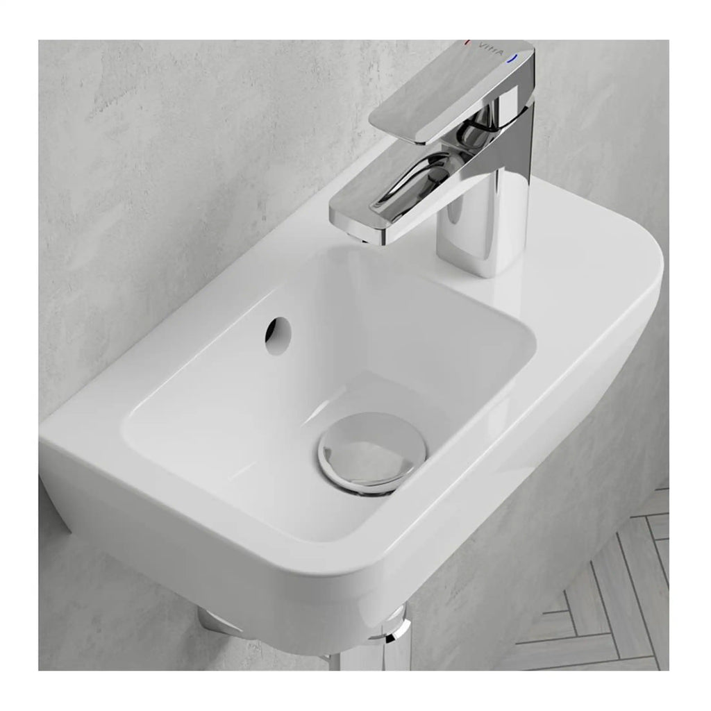 Contemporary white ceramic bathroom sink with chrome faucet, wall-mounted design, ideal for modern bathroom decor and hygiene needs.
