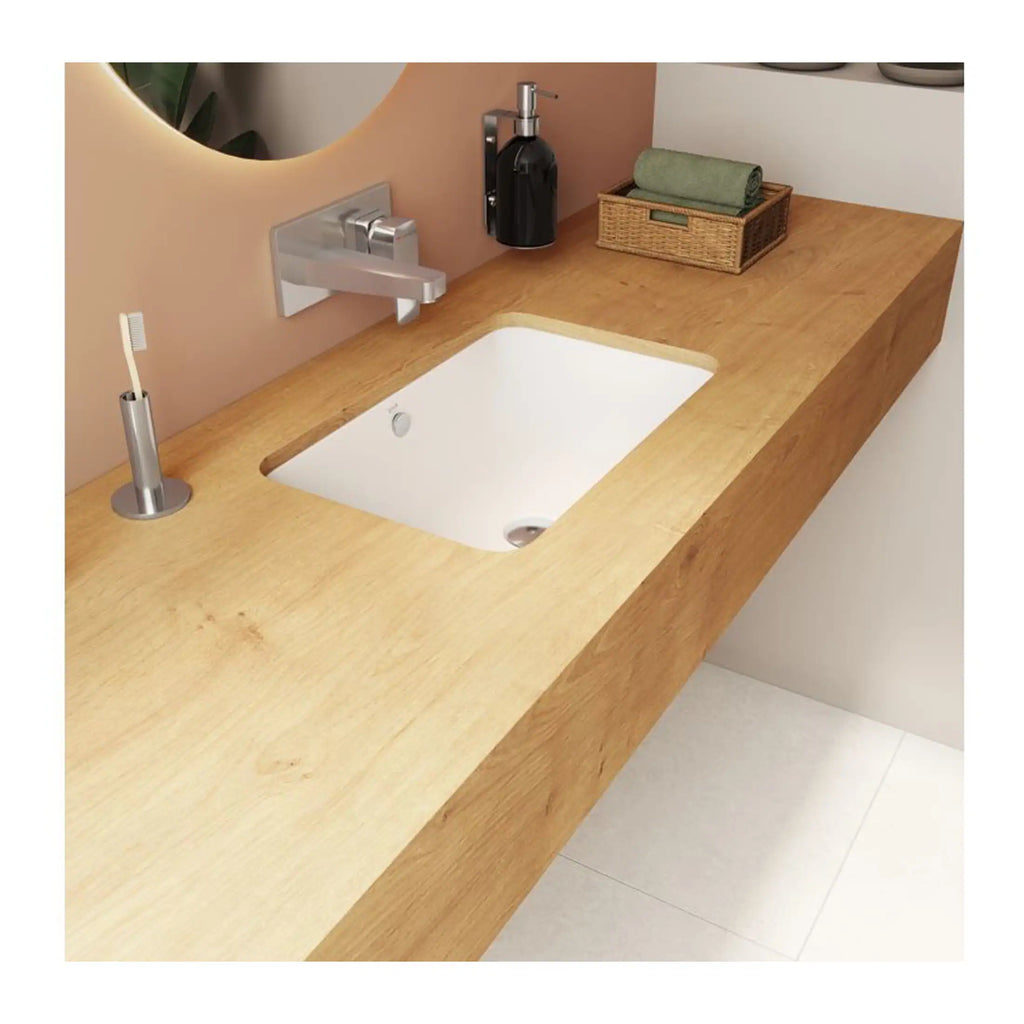 Natural wood bathroom vanity with built-in sink, chrome faucet, black soap dispenser, and wicker basket, creating a modern and eco-friendly bathroom décor.
