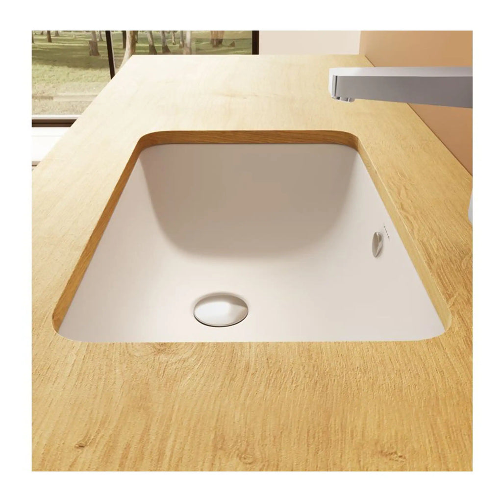 Sleek white kitchen sink with wooden edging, integrated into a modern wooden countertop, featuring a minimalist tap, ideal for contemporary bathroom or kitchen renovations.