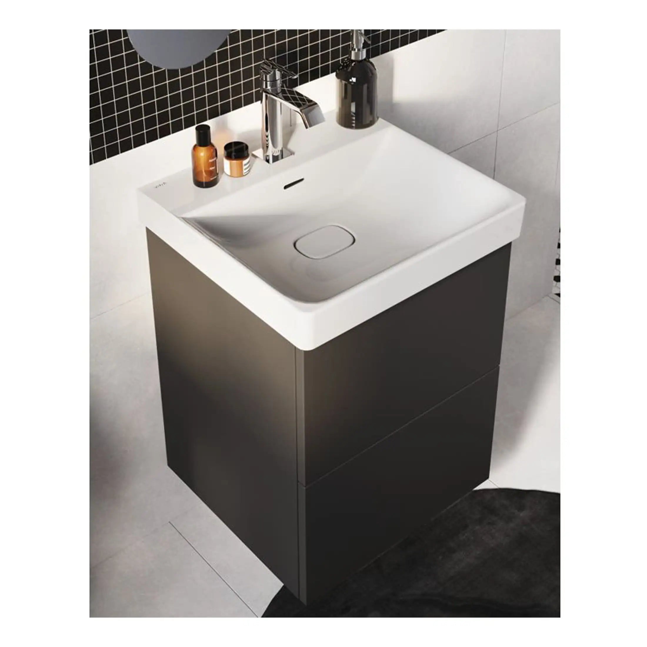 Modern bathroom vanity with a sleek black base and white ceramic sink featuring a contemporary chrome faucet, minimalist design ideal for stylish bathroom interiors.