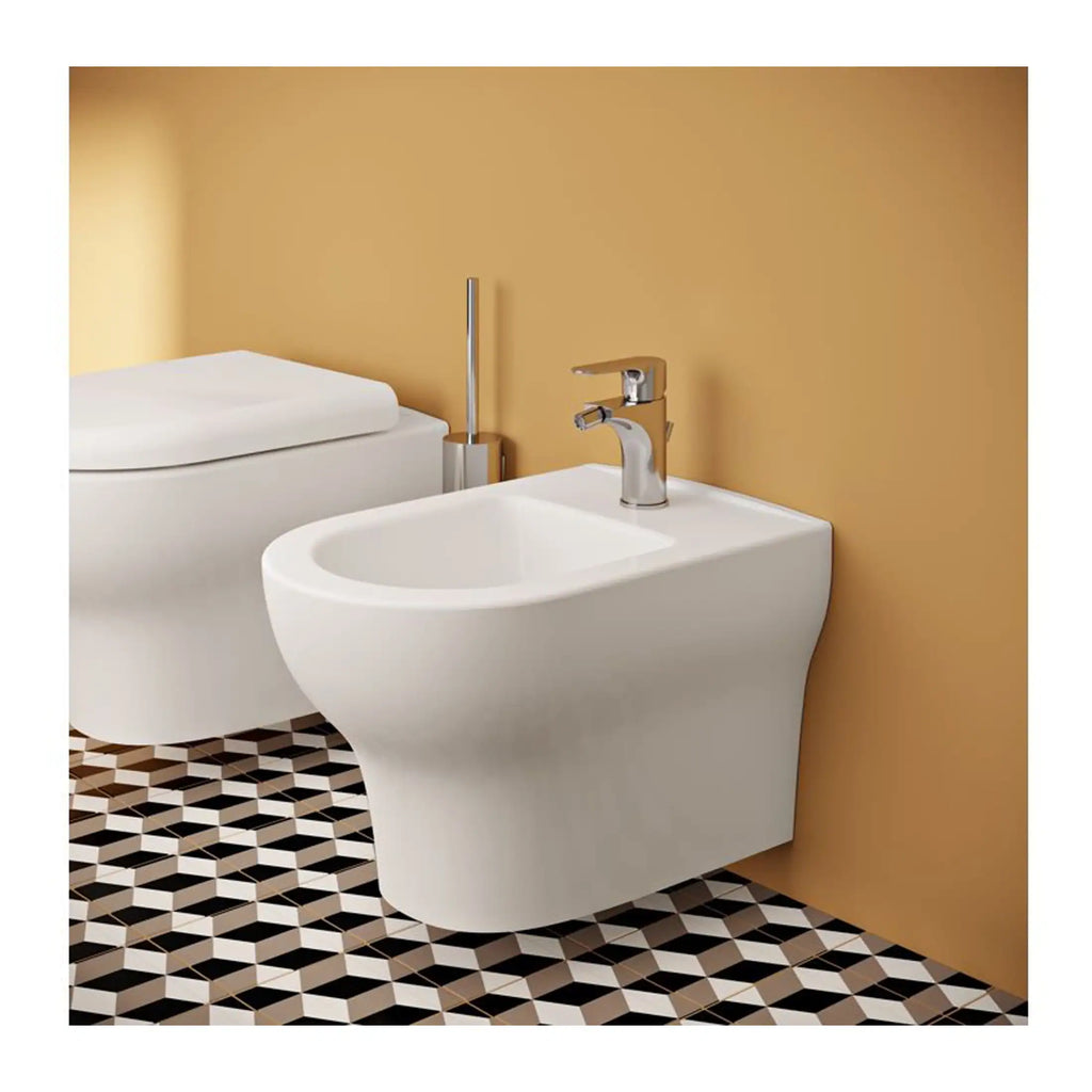 Sleek modern bidet and toilet in a contemporary bathroom with colourful geometric patterned floor tiles, highlighting stylish bathroom fixtures and design.
