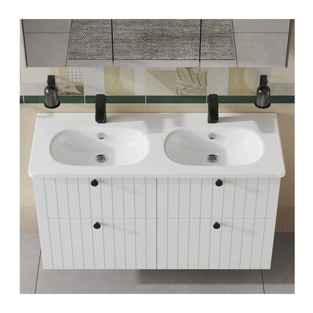 Double white bathroom vanity sink with two black taps and storage cabinet beneath, mounted on wall with decorative tiles; ideal for modern bathroom decor.