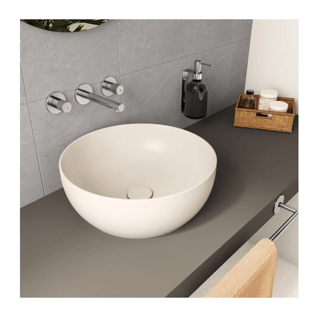 Organic white vessel sink bowl with modern chrome wall-mounted tap and minimalist bathroom accessories for elegant bathroom design.