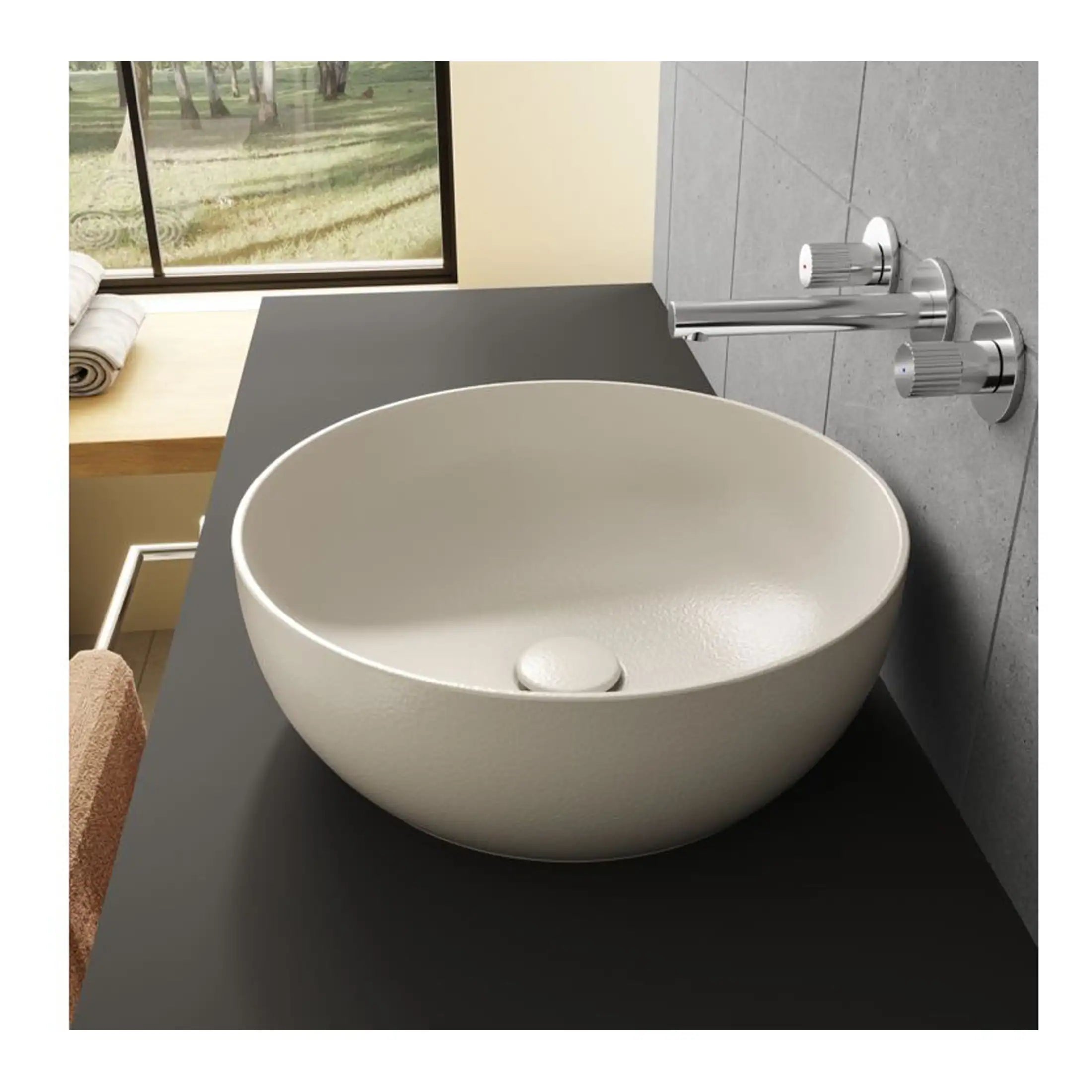 Sleek white countertop bathroom basin with modern chrome taps and fixtures, set against a minimalist grey tiled wall in a stylish, contemporary bathroom.