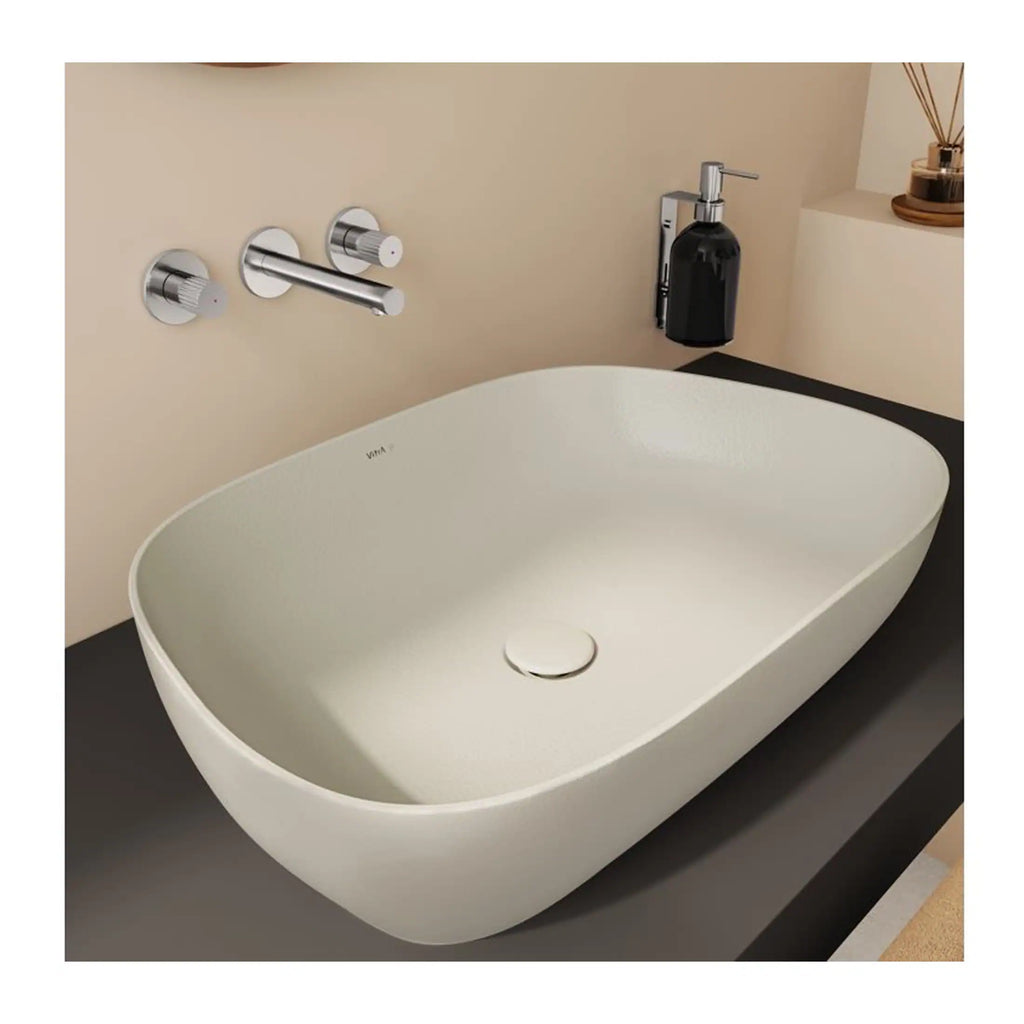 Sleek modern freestanding bathroom bathtub with minimalist chrome wall-mounted controls, black soap dispenser, and elegant neutral decor, perfect for contemporary bathroom designs.