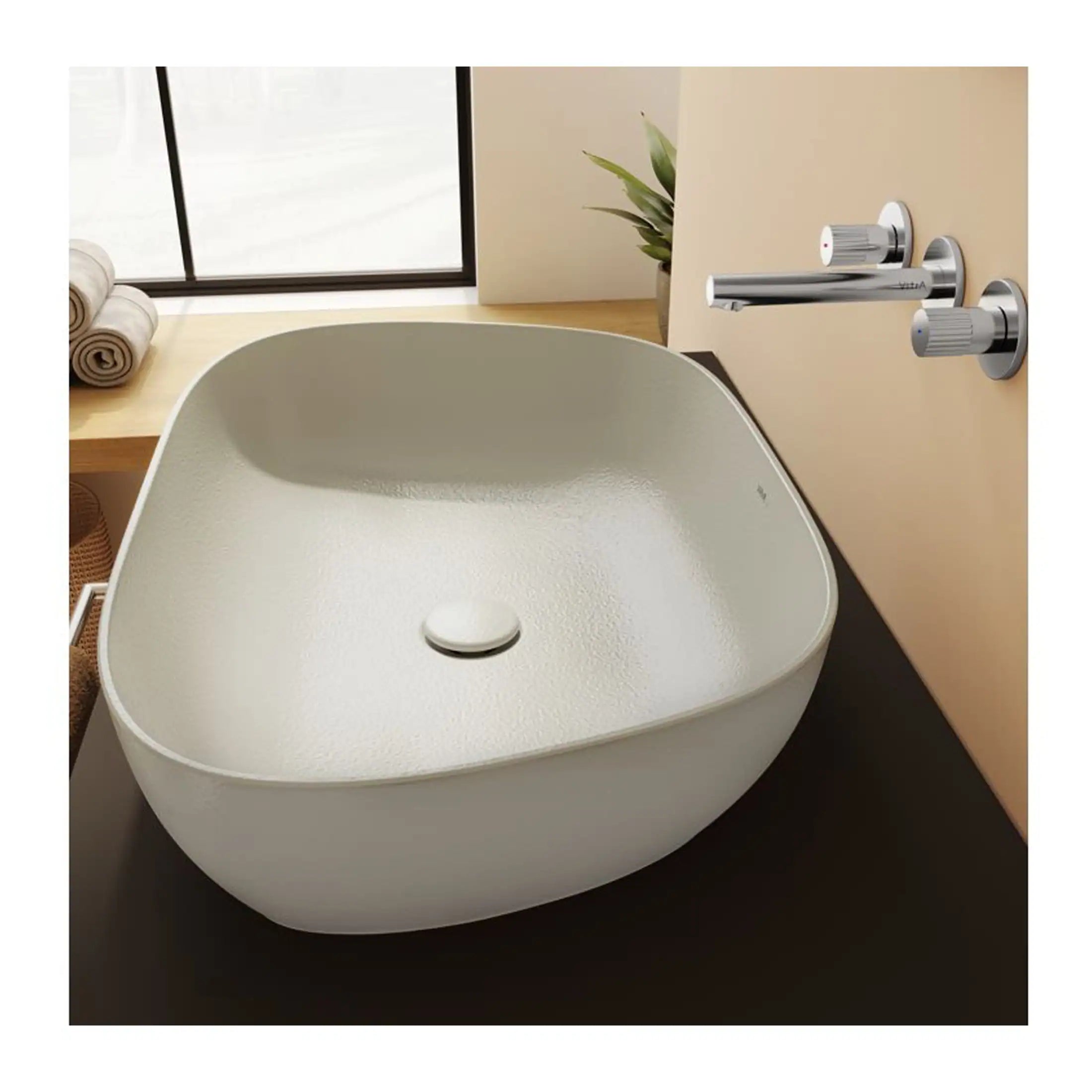 Sleek white bathroom sink with modern chrome taps and textured basin, ideal for contemporary bathroom design. Features minimalistic style and practical drainage, perfect for stylish, functional bathrooms.