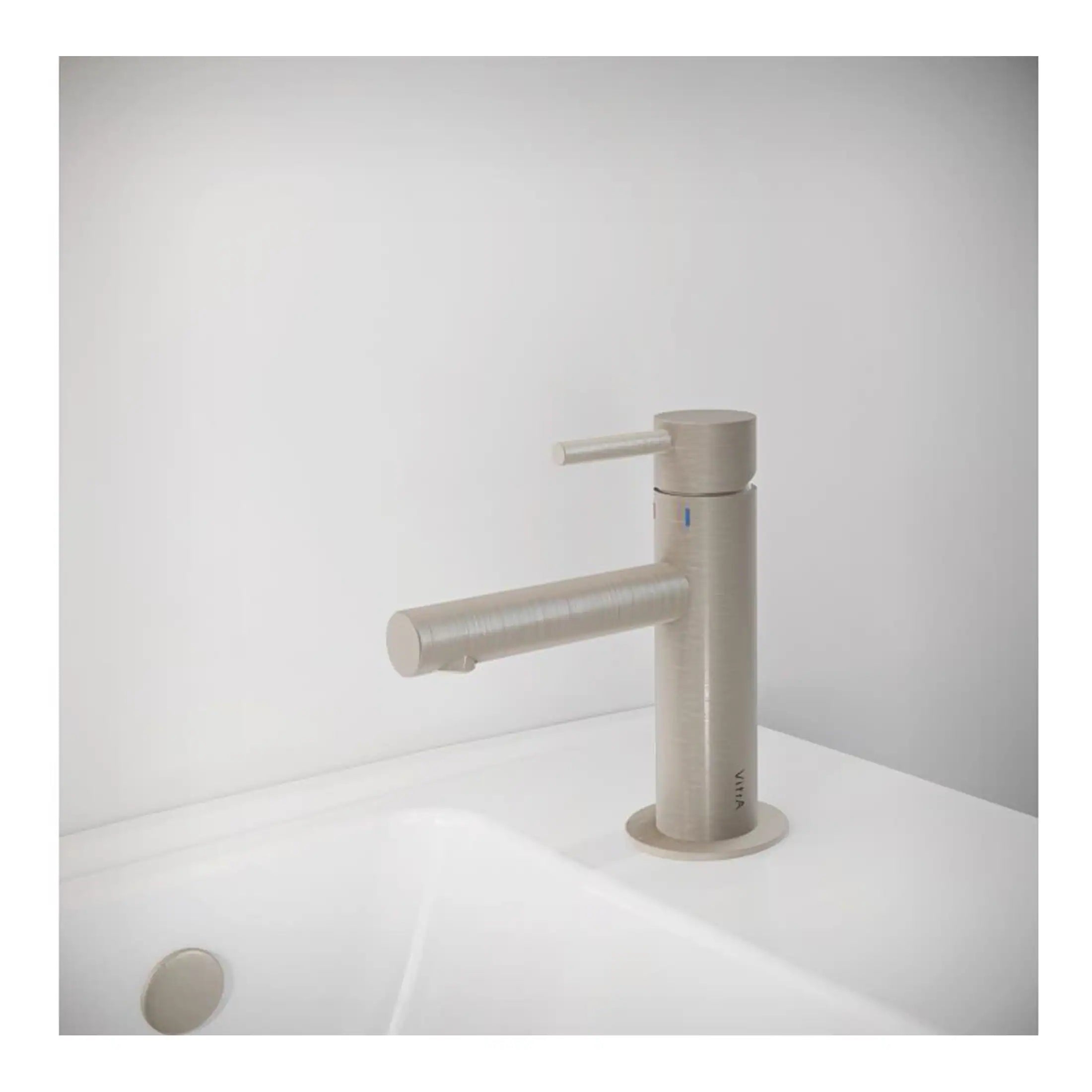 Sleek modern stainless steel bathroom tap mounted on a white sink, featuring a minimalist design suitable for contemporary bathroom decor. Perfect for enhancing bathroom aesthetics and functionality.