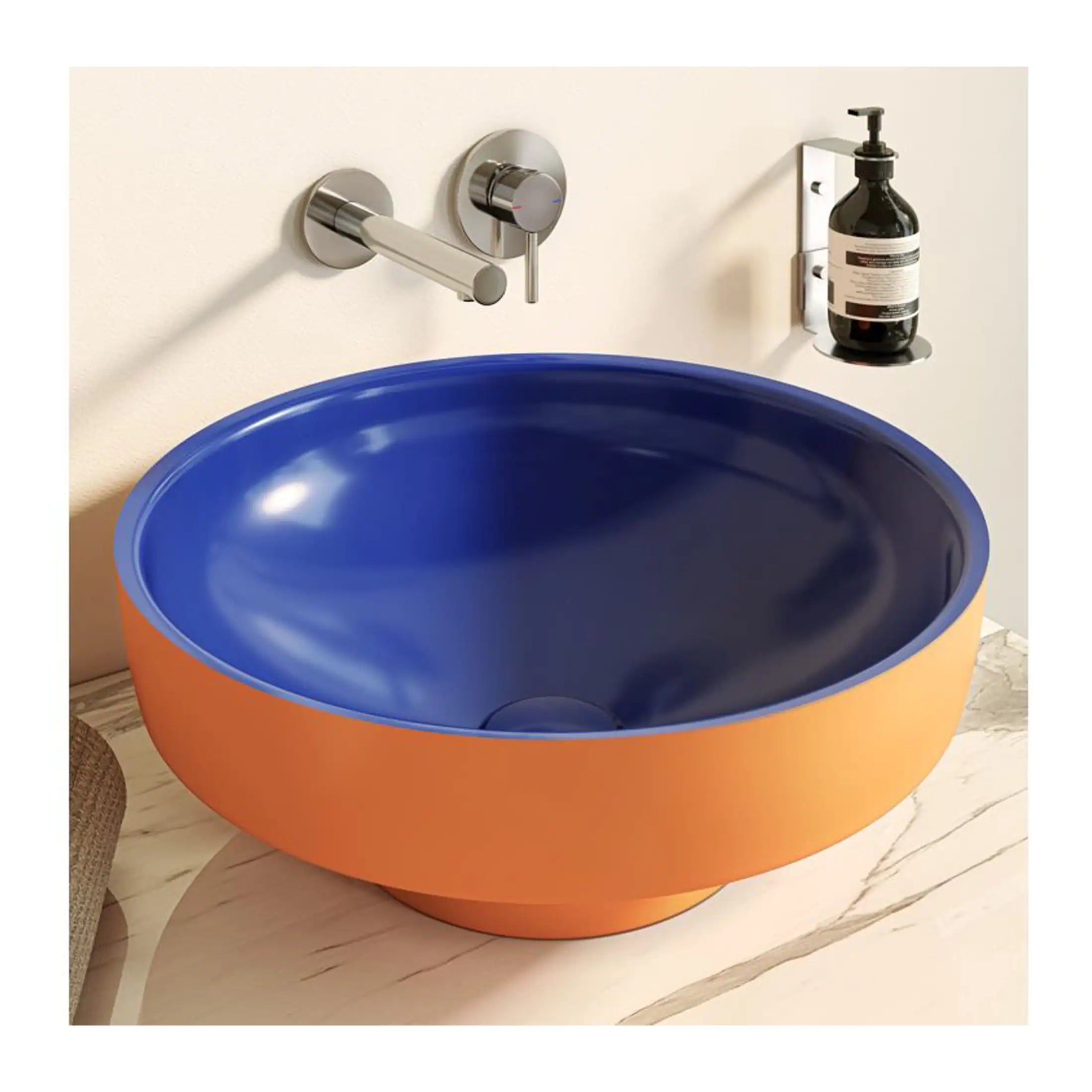 Bright blue and orange modern bathroom sink with sleek chrome faucet and wall-mounted soap dispenser, designed for stylish and functional bathroom decor.