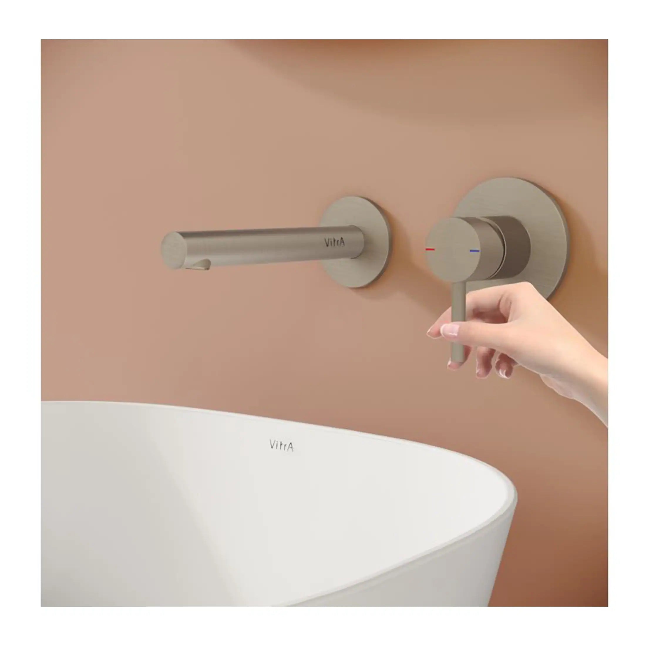 Sleek modern bathroom tap and temperature control valve in brushed stainless steel with minimalistic design.