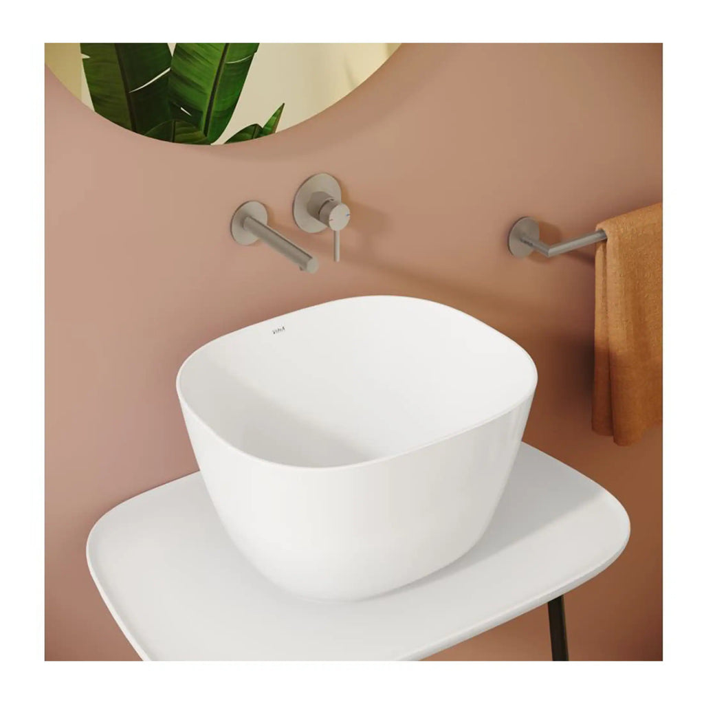 Contemporary bathroom basin with matte chrome tap and wall-mounted accessories, minimalistic design, perfect for modern small bathrooms or powder rooms.