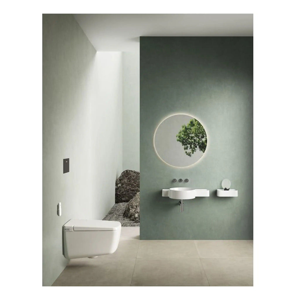 Modern minimalist bathroom with wall-mounted toilet, floating vanity with integrated sink, and large round mirror with backlit lighting; neutral tones and sleek design.