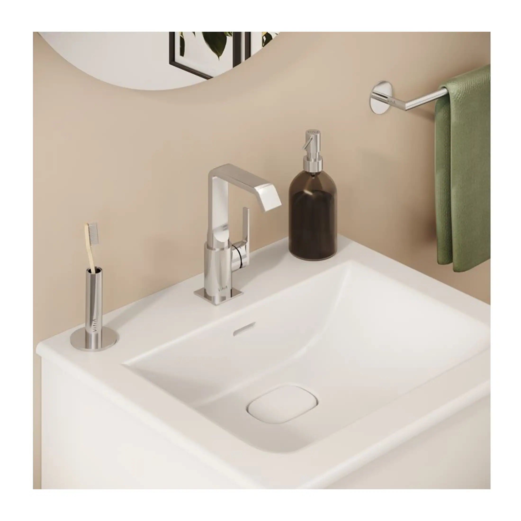 Elegant bathroom sink with modern chrome fixtures, soap dispenser, and toothbrush holder, complemented by a green towel on a sleek towel rail for a stylish bathroom decor.