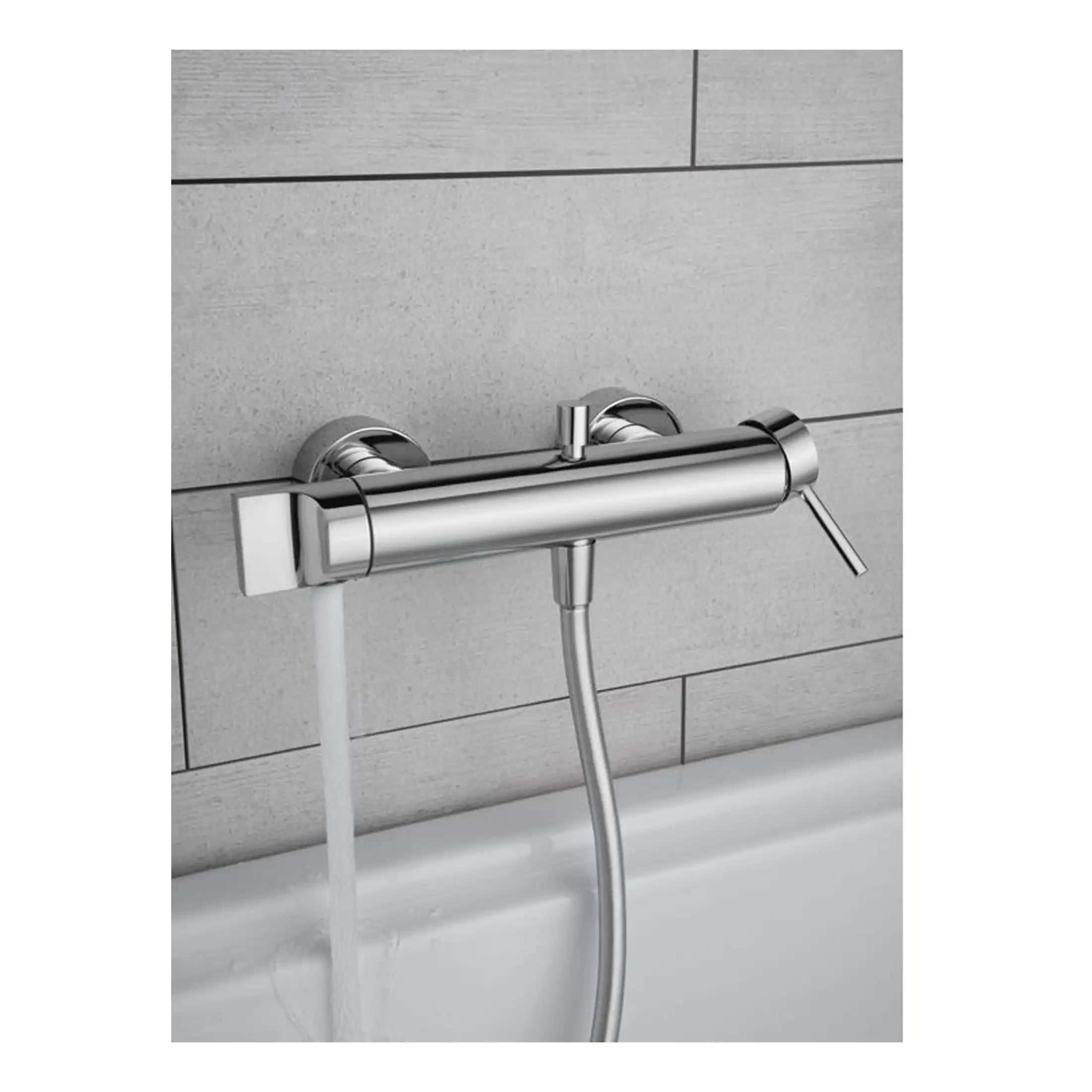 Smooth chrome bath mixer tap with water flow and handheld shower attachment in a modern bathroom setting. Perfect for stylish and functional bathing spaces.
