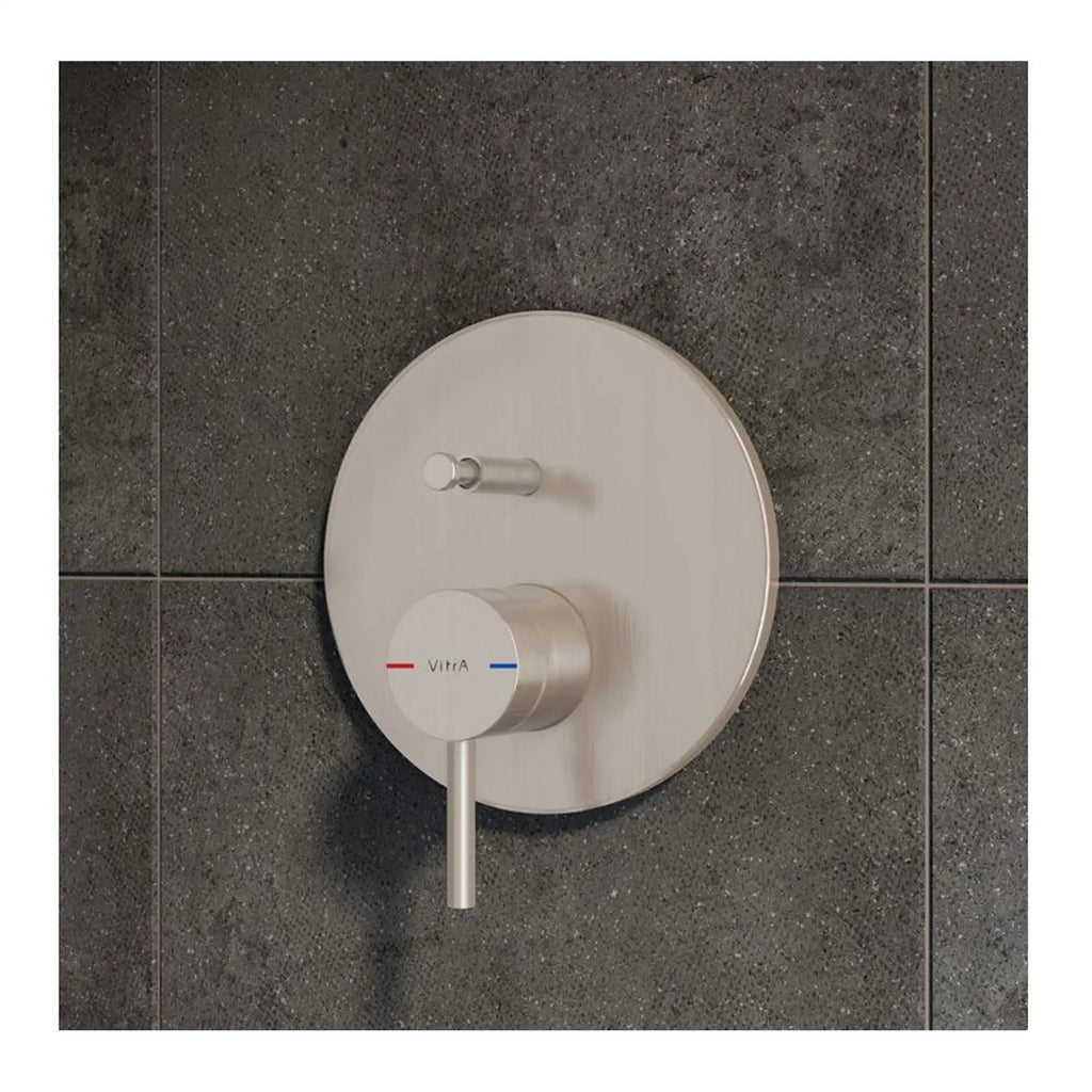 Sleek modern thermostatic shower control with textured brushed stainless steel finish, mounted on dark tiled wall, for precise temperature regulation in contemporary bathrooms.