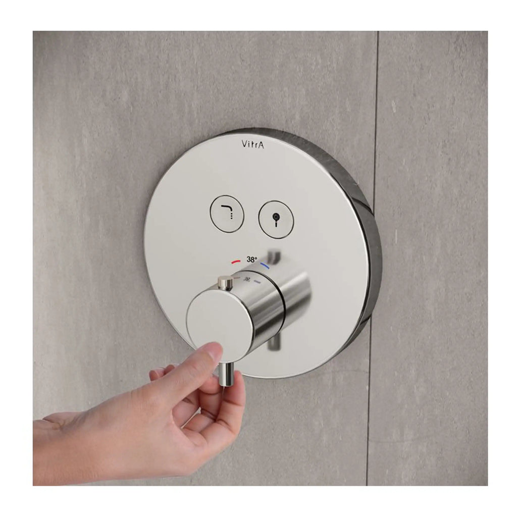 Modern shower thermostat control with temperature adjustment on tiled bathroom wall, showcasing sleek, contemporary bathroom fixtures.