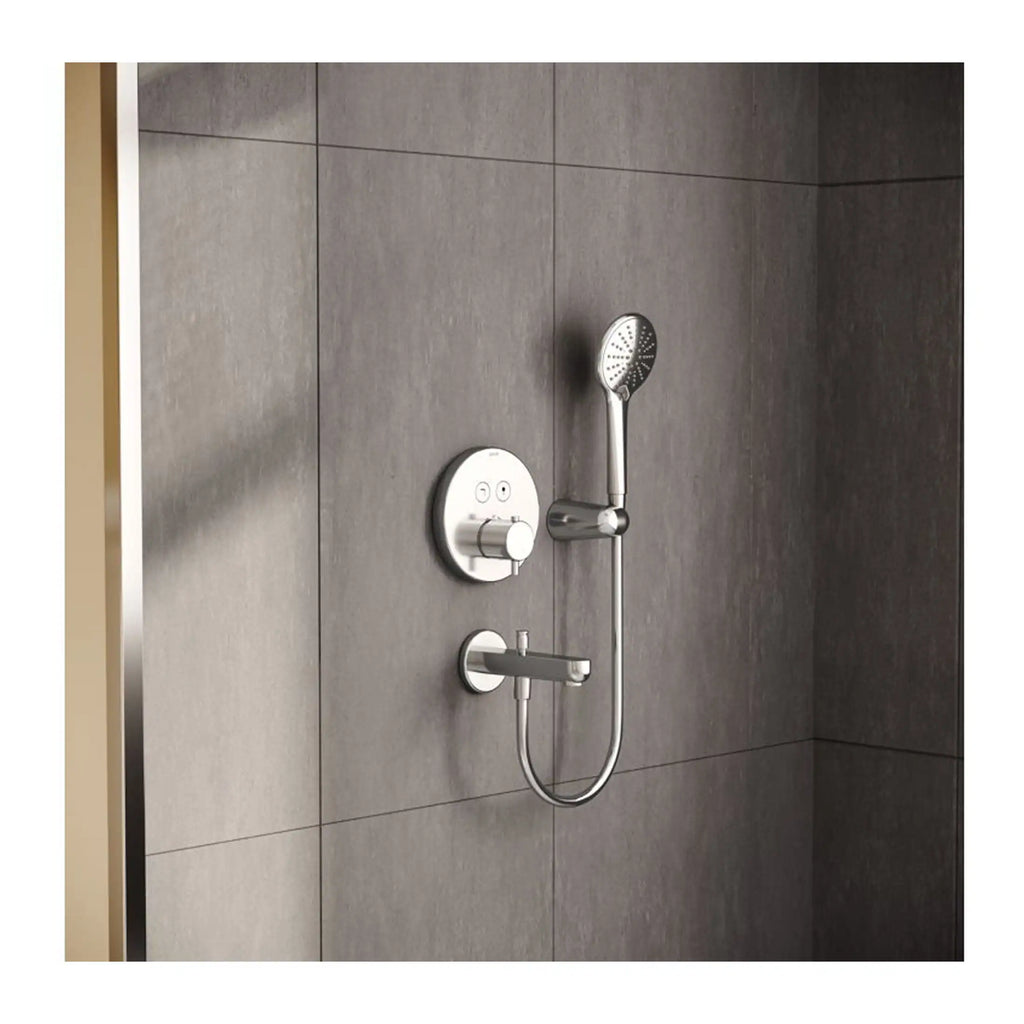Modern shower head and thermostatic mixer valve installed on a grey tiled bathroom wall for a sleek, contemporary showering experience.