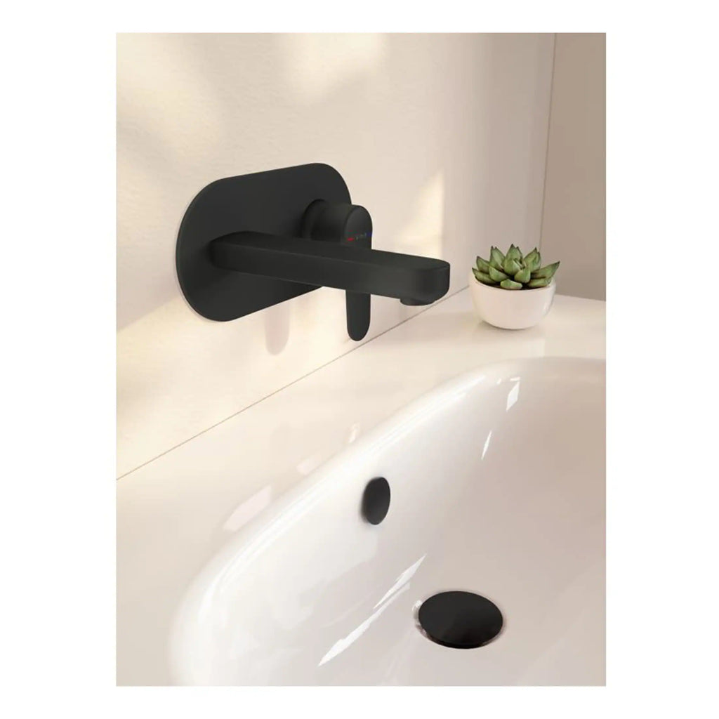 Sleek black wall-mounted bathroom tap with a modern design, installed above a white bathtub, accompanied by a small potted succulent plant for contemporary bathroom decor.