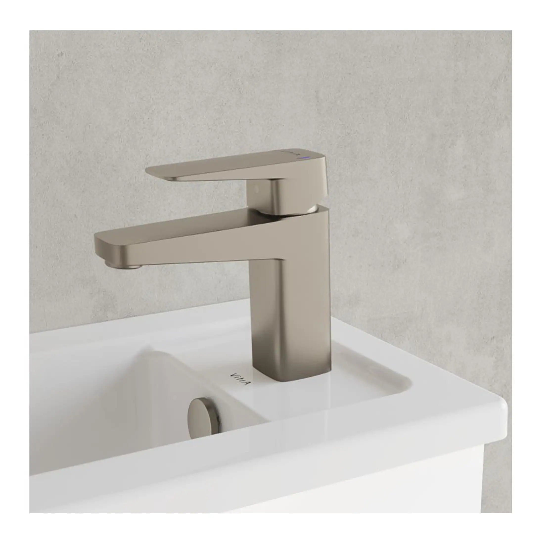 Modern brushed nickel bathroom sink tap fitting on a white ceramic basin, suitable for contemporary bathroom design.