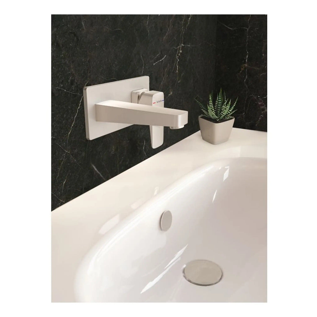 Sleek white bathroom tap with black marble wall background, modern design for luxurious bathroom decor.