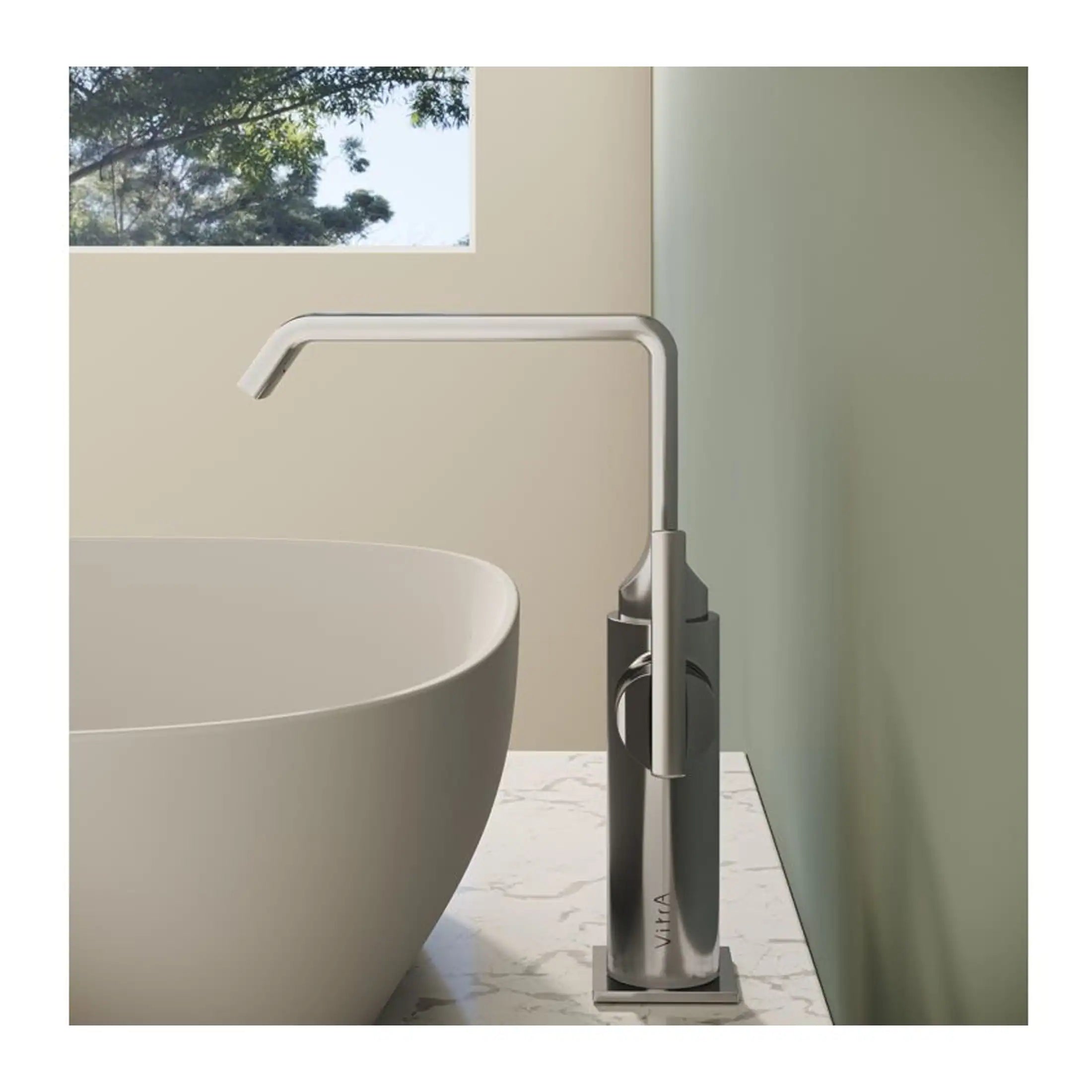 Modern freestanding bathtub with sleek, minimalist tall bathtub mixer tap in a contemporary bathroom setting. The design emphasizes luxury and clean lines for a stylish bathroom upgrade.