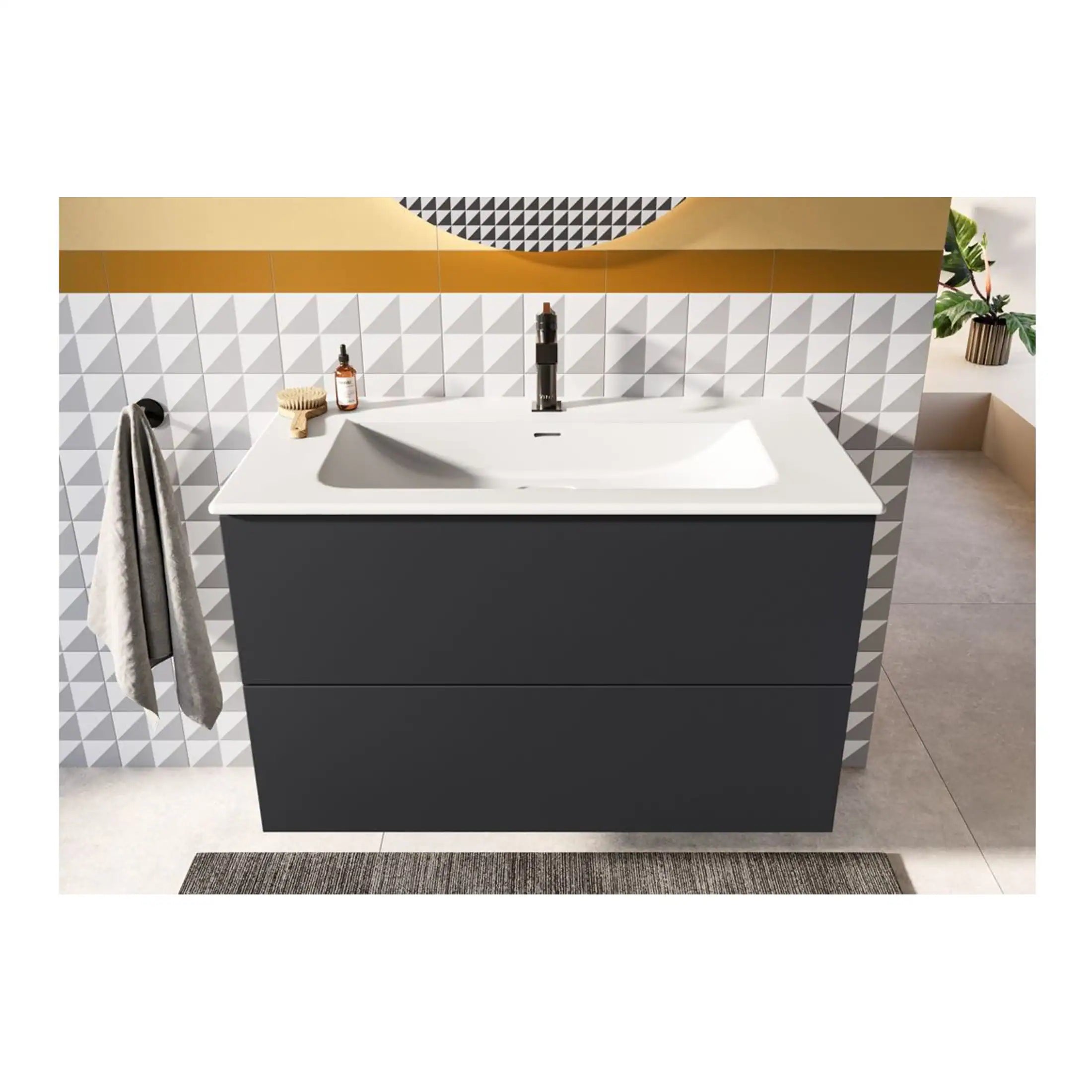 Modern bathroom vanity with sleek black cabinetry and white countertop, featuring a stylish undermount sink and contemporary black faucet. Perfect for contemporary bathroom design with geometric wall tiles.