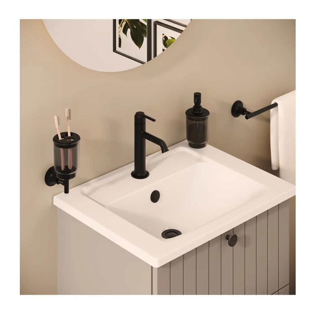 Natural black bathroom fixtures including a matte black tap, soap dispenser, toothbrush holder, and towel rail in a stylish modern bathroom setting.