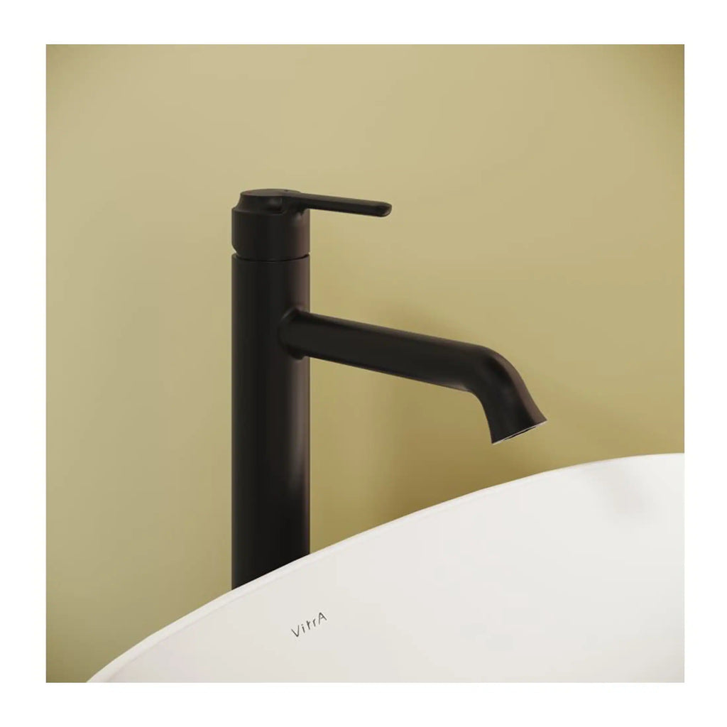 Sleek black bathroom tap next to a modern white bathtub with "Vitra" branding, featuring minimalistic design ideal for contemporary bathroom renovations.