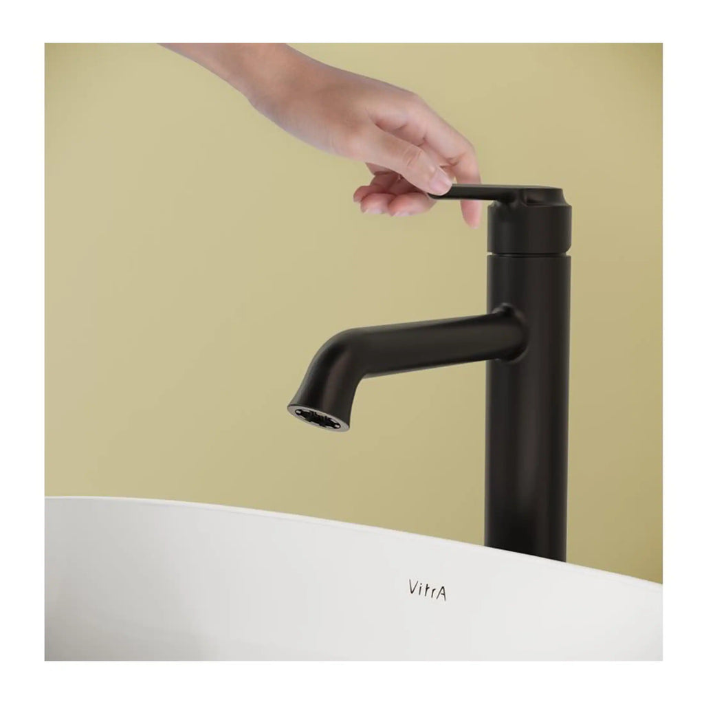 Sleek black kitchen or bathroom tap with modern design, featuring a single lever for easy water control, installed over a stylish white basin with the brand name Vitra.