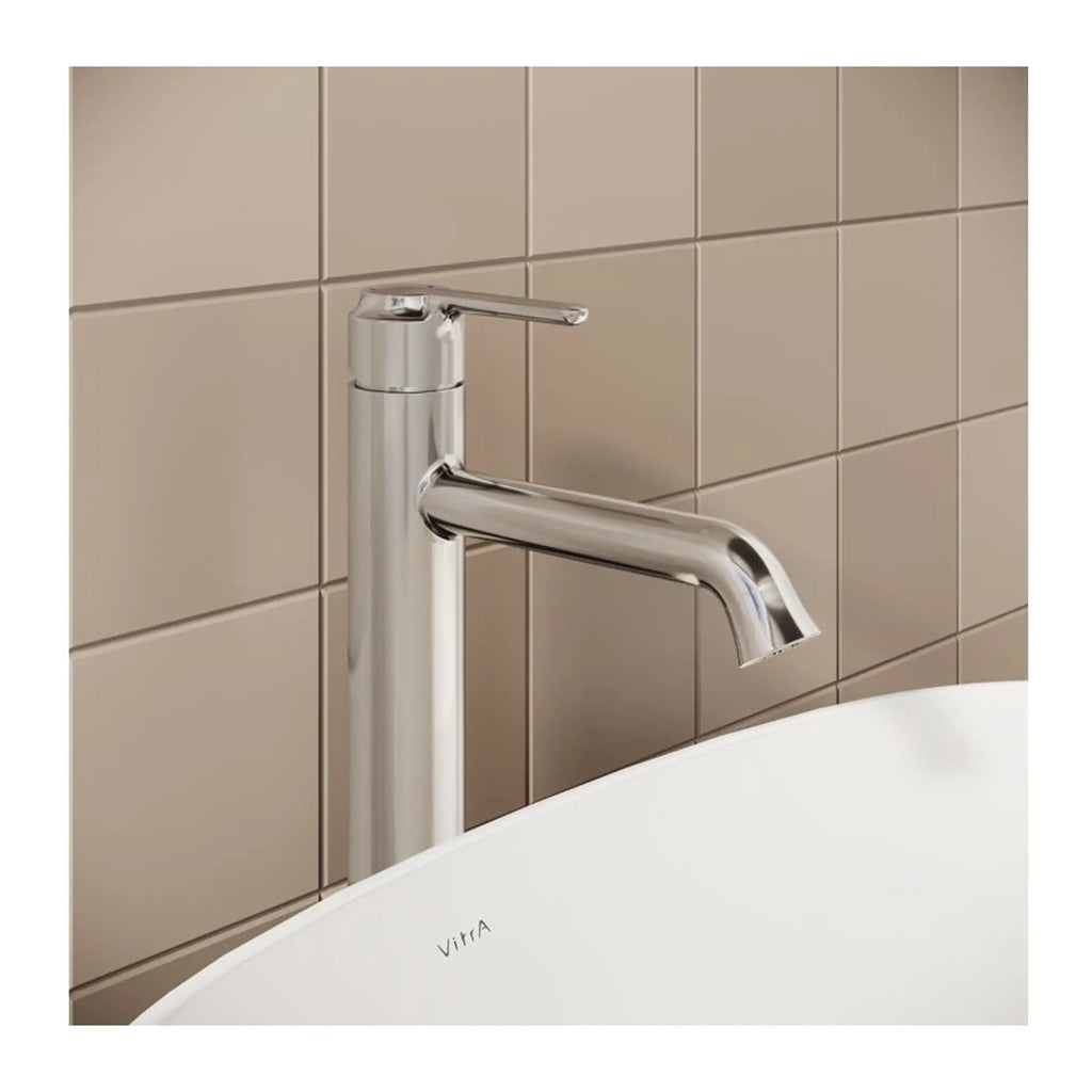 Sleek modern chrome bathroom tap installed above a white bathtub with beige tiled wall background, perfect for contemporary bathroom design.