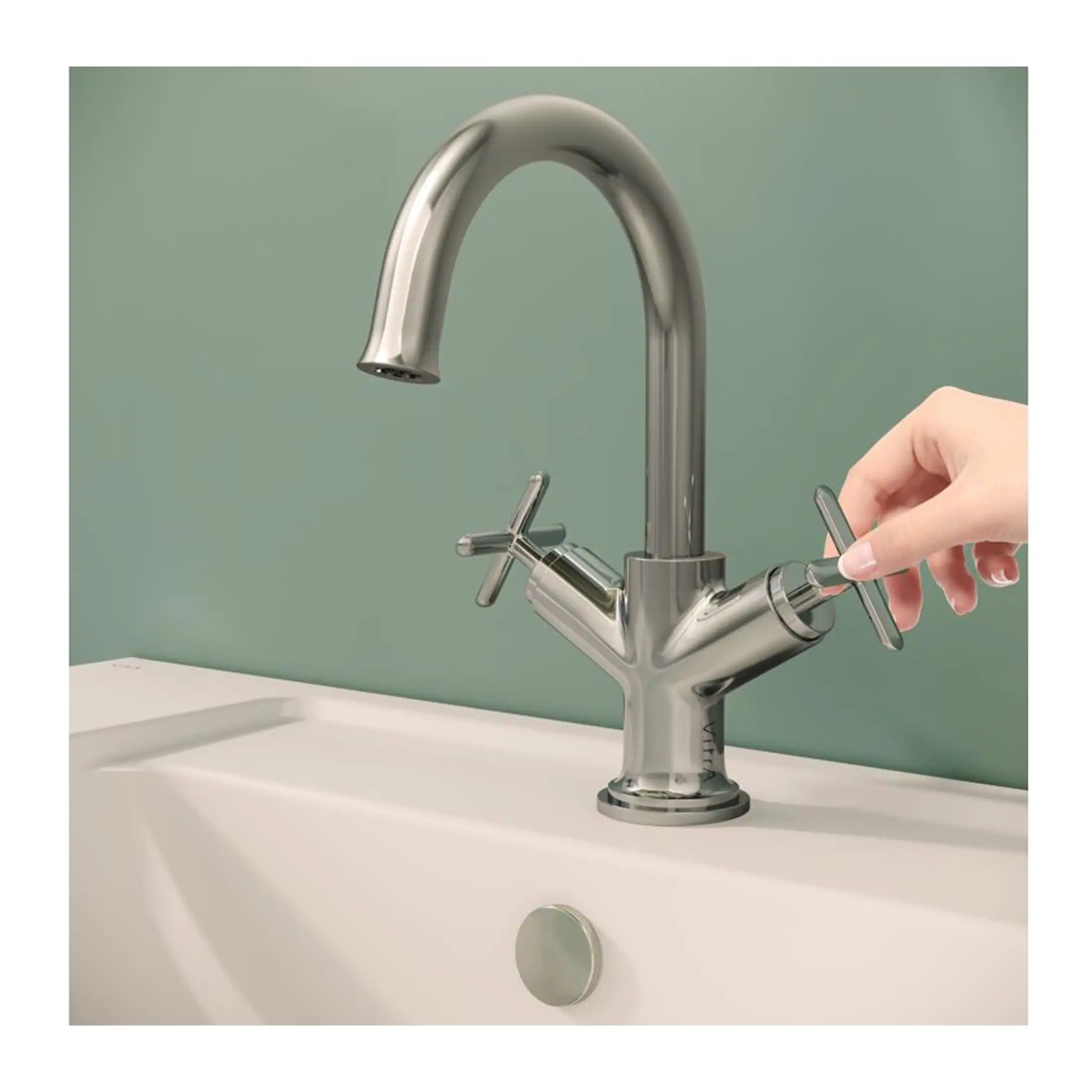 Brushed stainless steel kitchen faucet with dual handles and high-arc spout, installed on a white sink, modern design, ideal for contemporary bathrooms and kitchens.