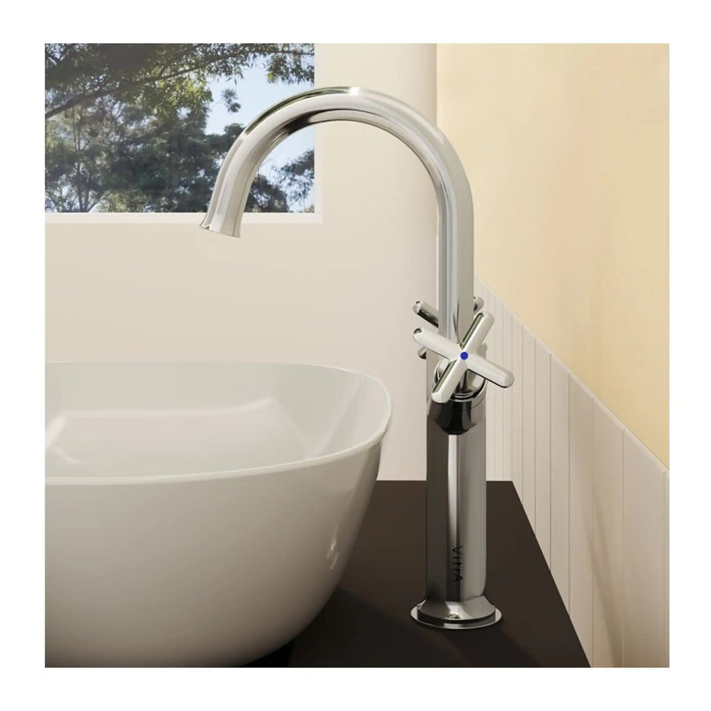 Brass bathroom mixer tap with modern cross handles next to a white bathtub, set in a contemporary bathroom with natural light and scenic window views, perfect for luxury bathroom design.