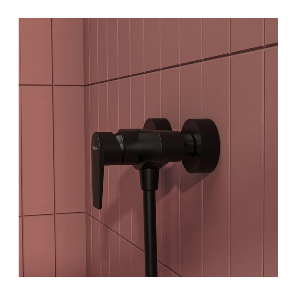 Stylish black shower valve mounted on pink tiled bathroom wall, modern and sleek design ideal for contemporary Bubly Bathrooms.