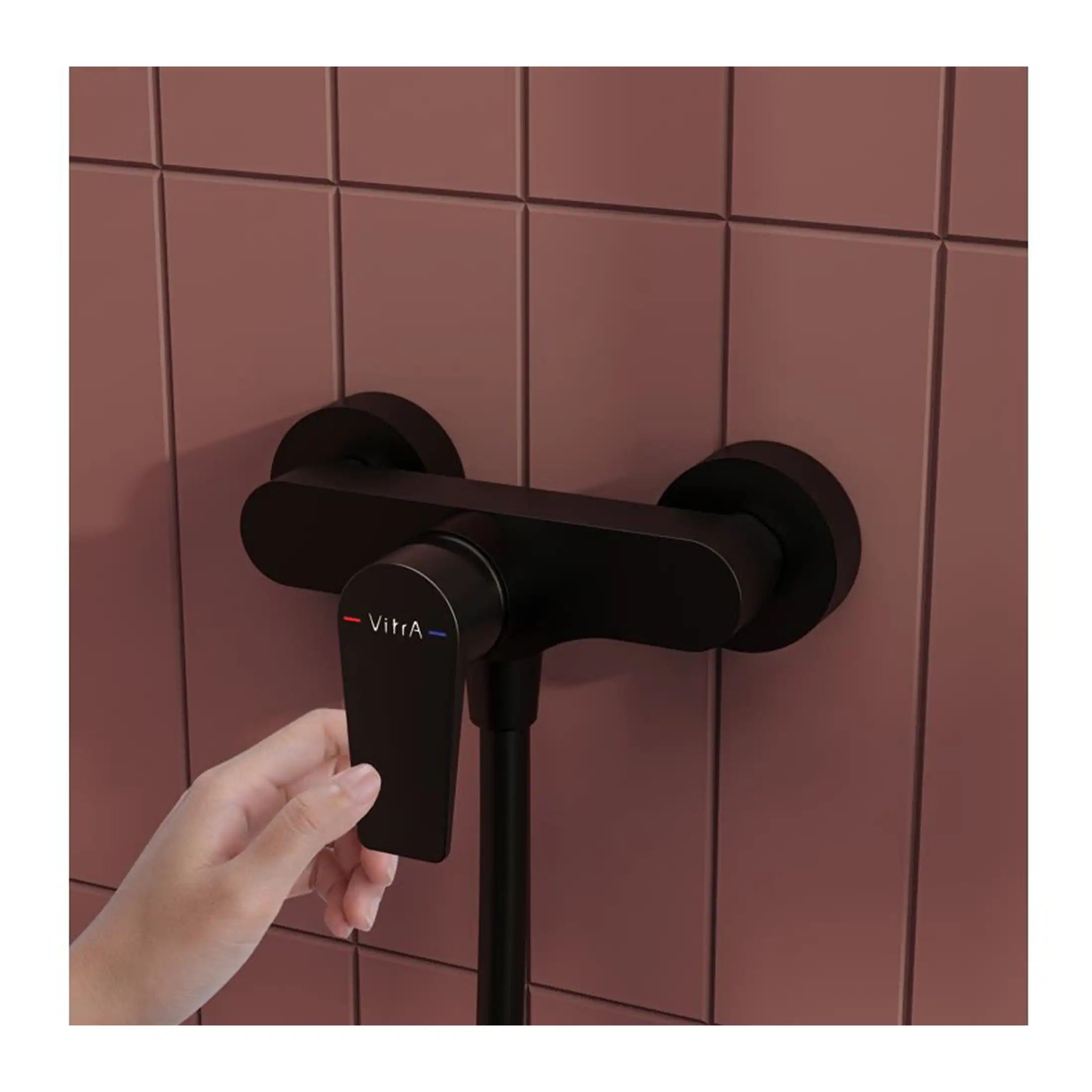 Vitra black modern tap control for stylish bathroom plumbing on pink tiled wall.
