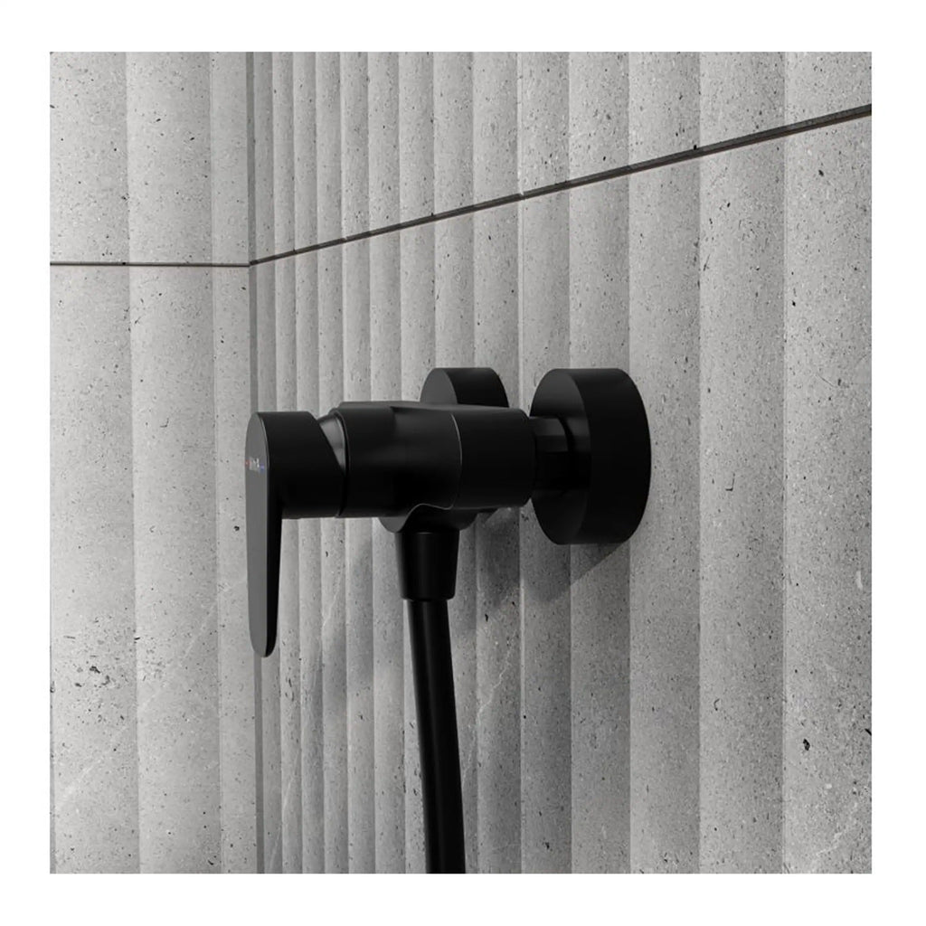Sleek black bathroom hot and cold water mixer tap mounted on textured grey wall tiles, modern bathroom fixtures, minimalist design.