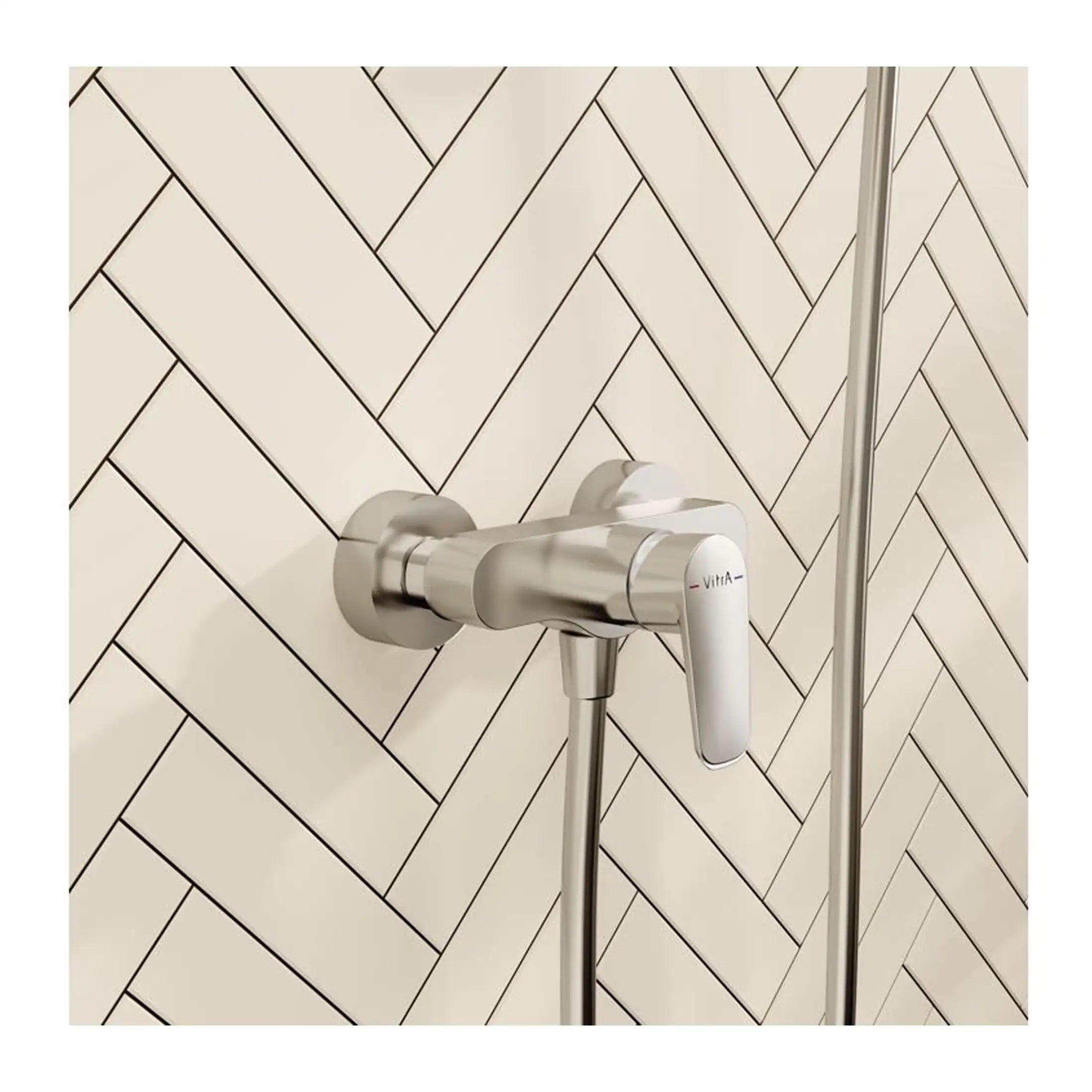 Sleek modern thermostatic shower valve with chrome finish on herringbone tiled bathroom wall. Professional installation of high-quality bath fixtures for contemporary bathroom designs.