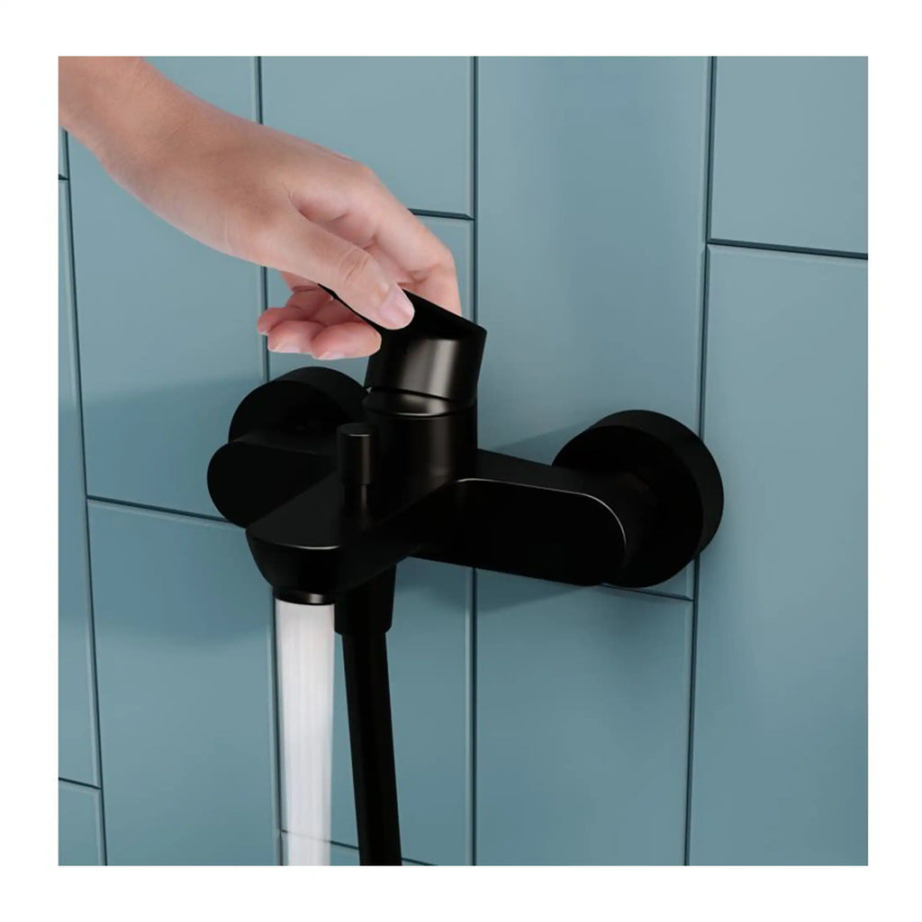 Black bathroom tap with a modern matte finish on a tiled wall, showing a hand adjusting the lever, ideal for contemporary bathroom interiors.