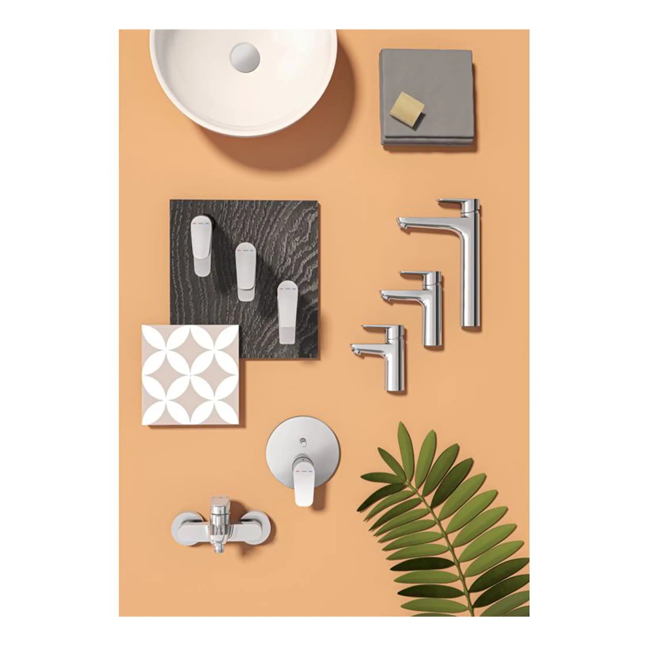 Sleek modern bathroom fixtures and accessories including chrome taps, a white sink, and decorative tiles arranged on a peach background with a green plant branch.