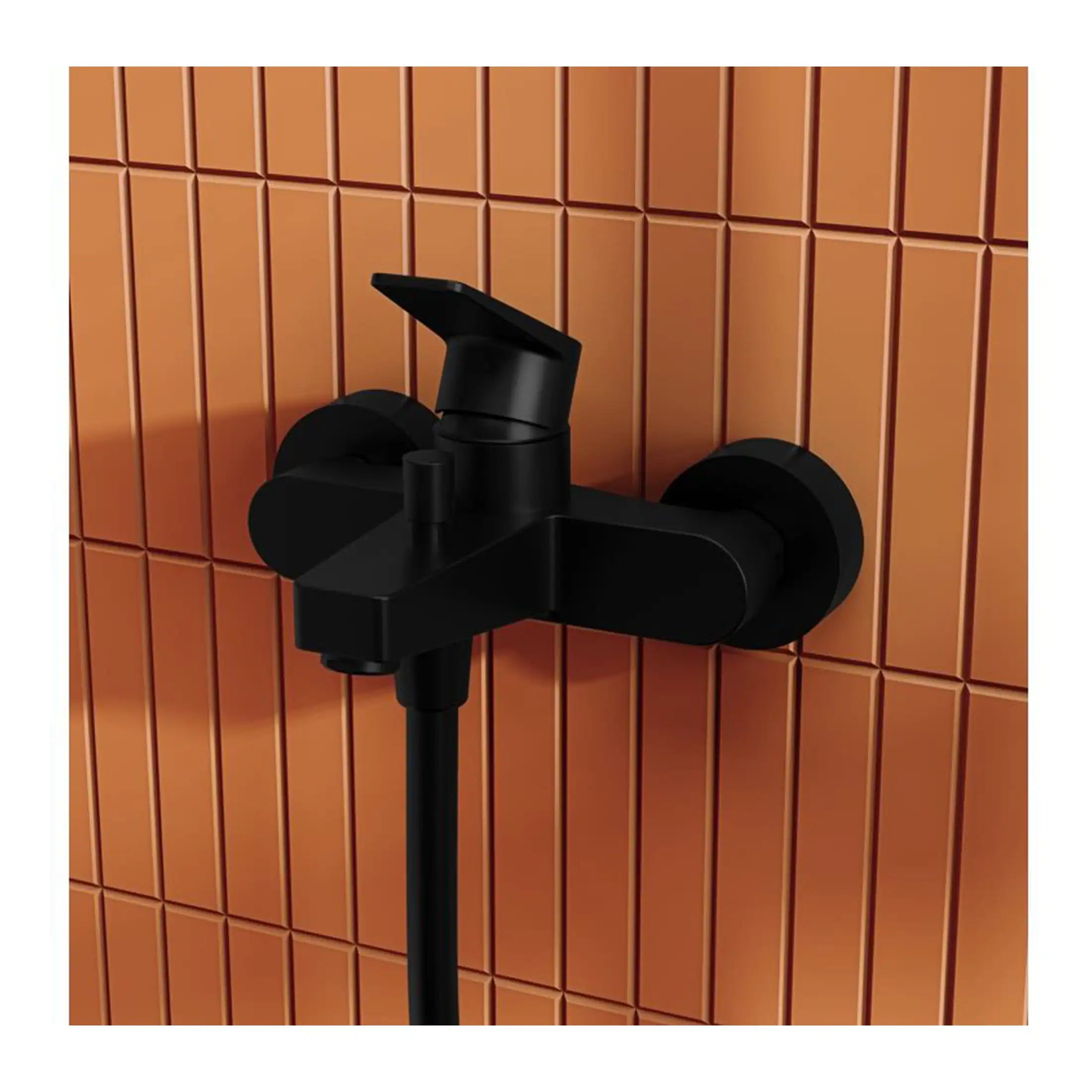 Black bathroom faucet mounted on wall with orange tiled background.