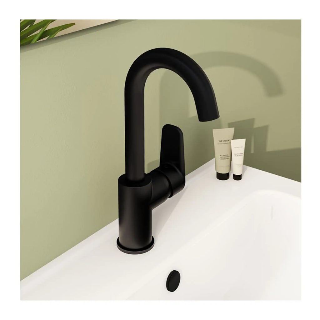 Sleek black bathroom sink faucet with modern design, mounted on a white sink with two cosmetic tubes nearby, set against a soft green wall, offering stylish and functional bathroom fixtures.
