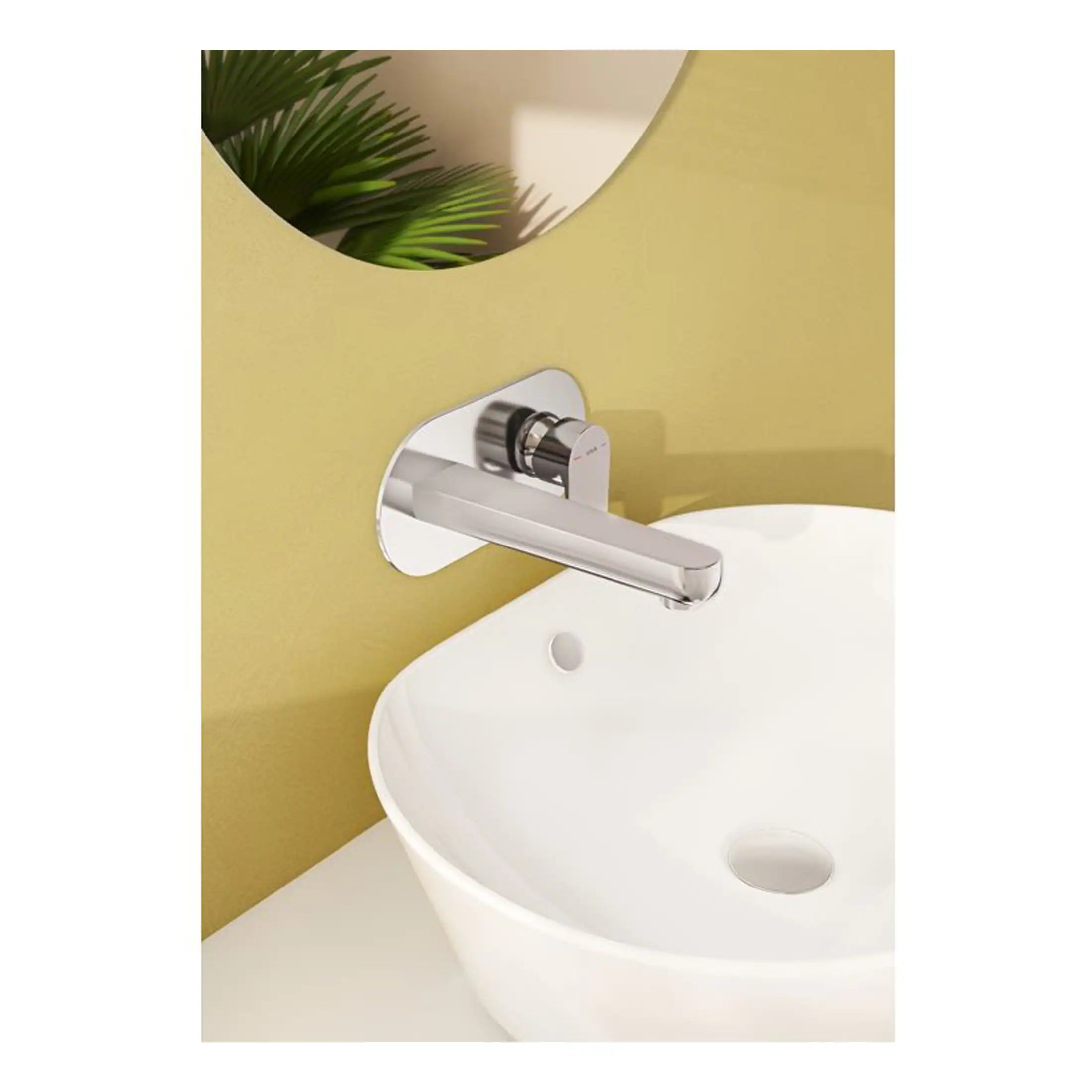 Smooth chrome bathroom mixer tap installed above a white ceramic sink in a modern bathroom with yellow wall and mirror.