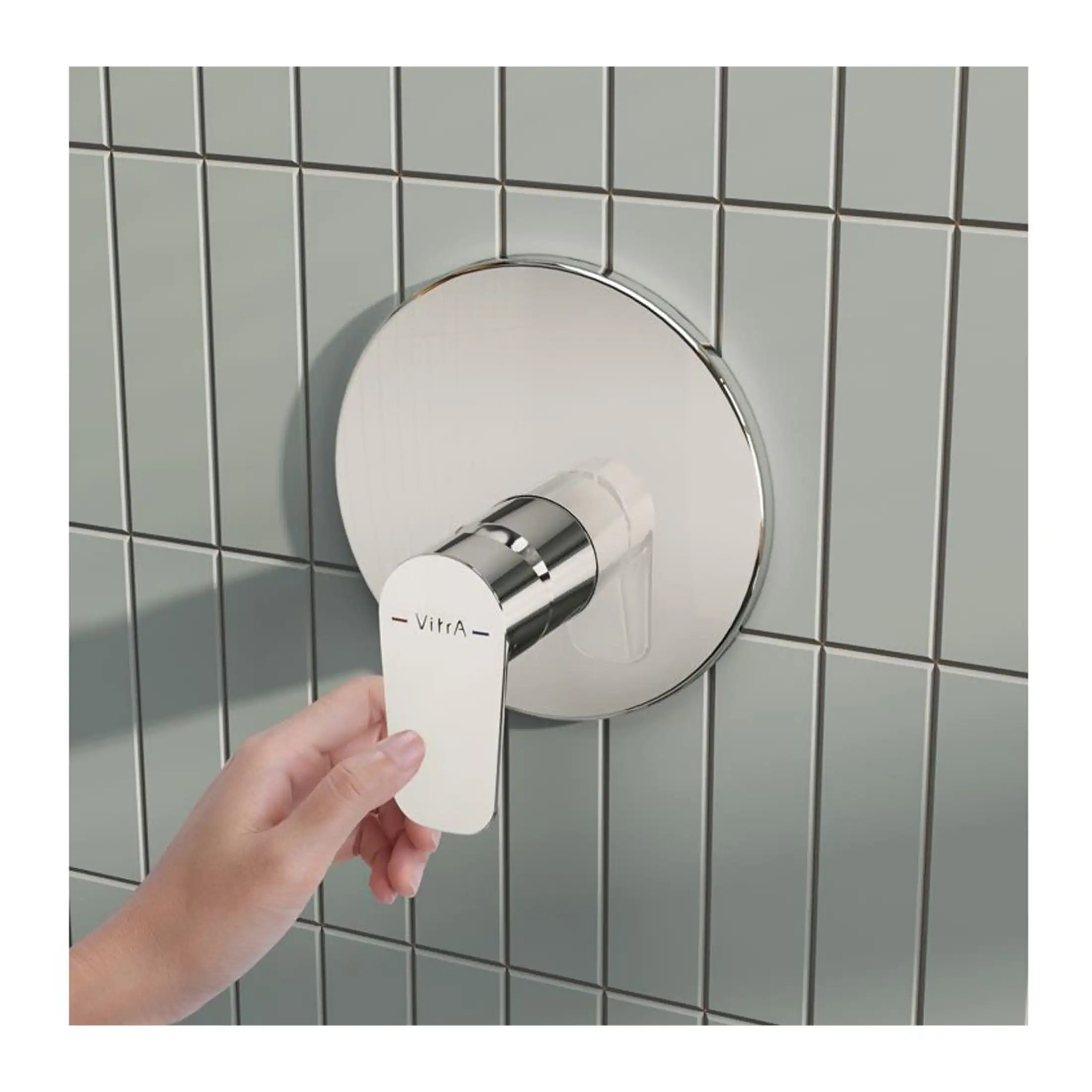 Shower valve with a modern chrome finish, installed on a tiled bathroom wall, controlled by a sleek hand-held lever for precise temperature and water flow management.