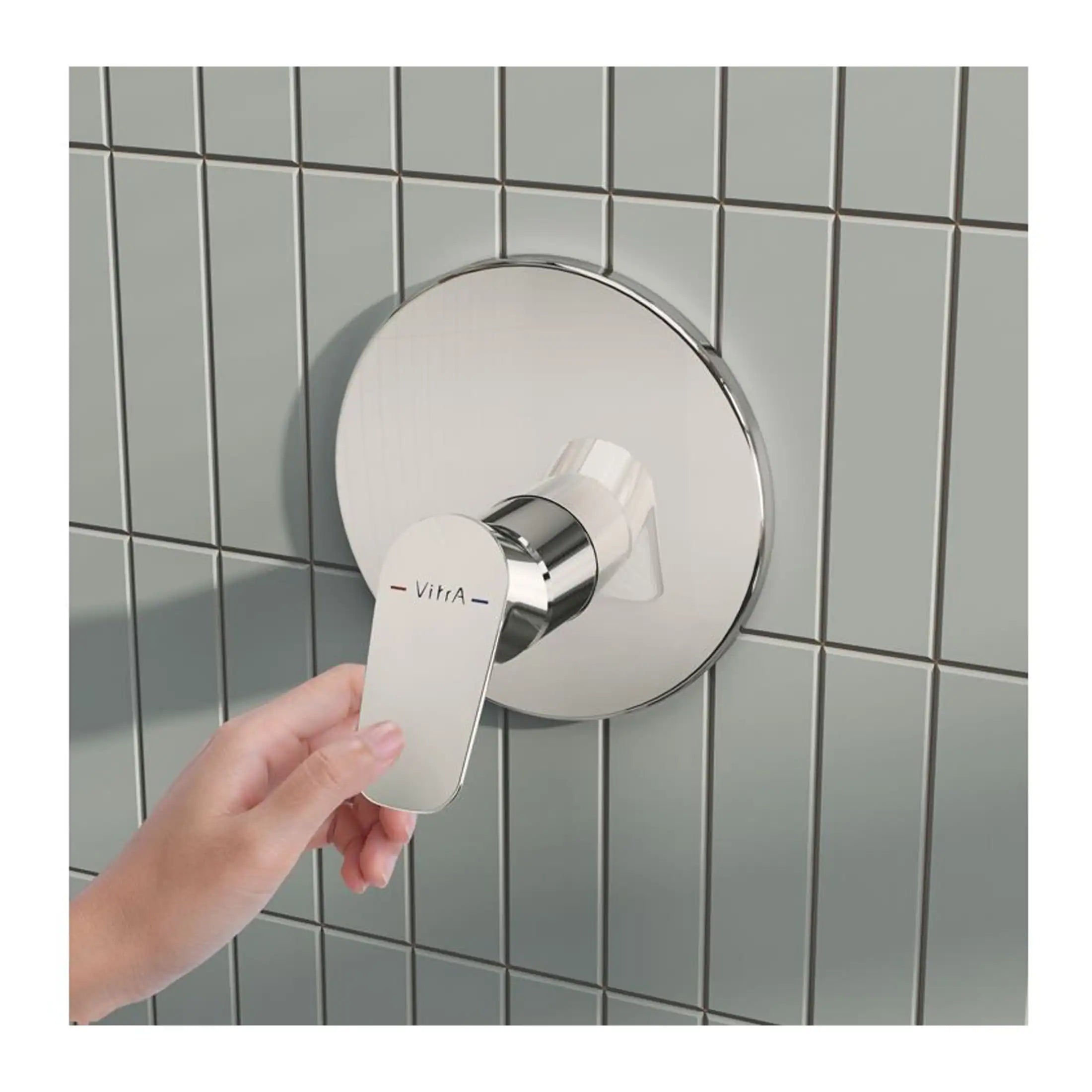 Shower temperature control knob with Vitra branding on a tiled wall, demonstrating modern and stylish bathroom fixtures.