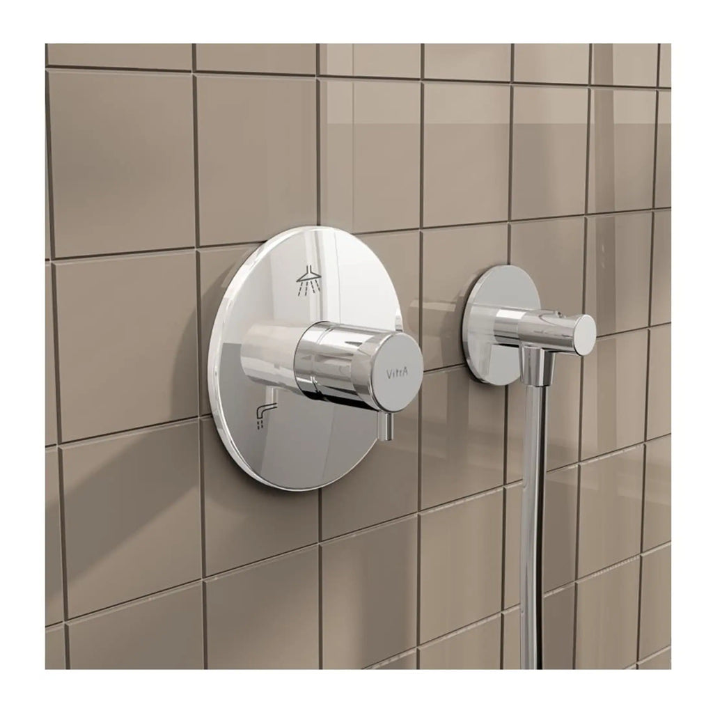 Sleek chrome shower control with matching wall-mounted handle on beige tiled bathroom wall, designed for modern bathroom aesthetics.