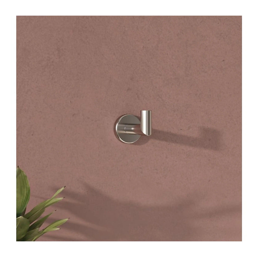 Sleek stainless steel towel hook mounted on a soft pink bathroom wall, ideal for modern bathroom organisation and storage.
