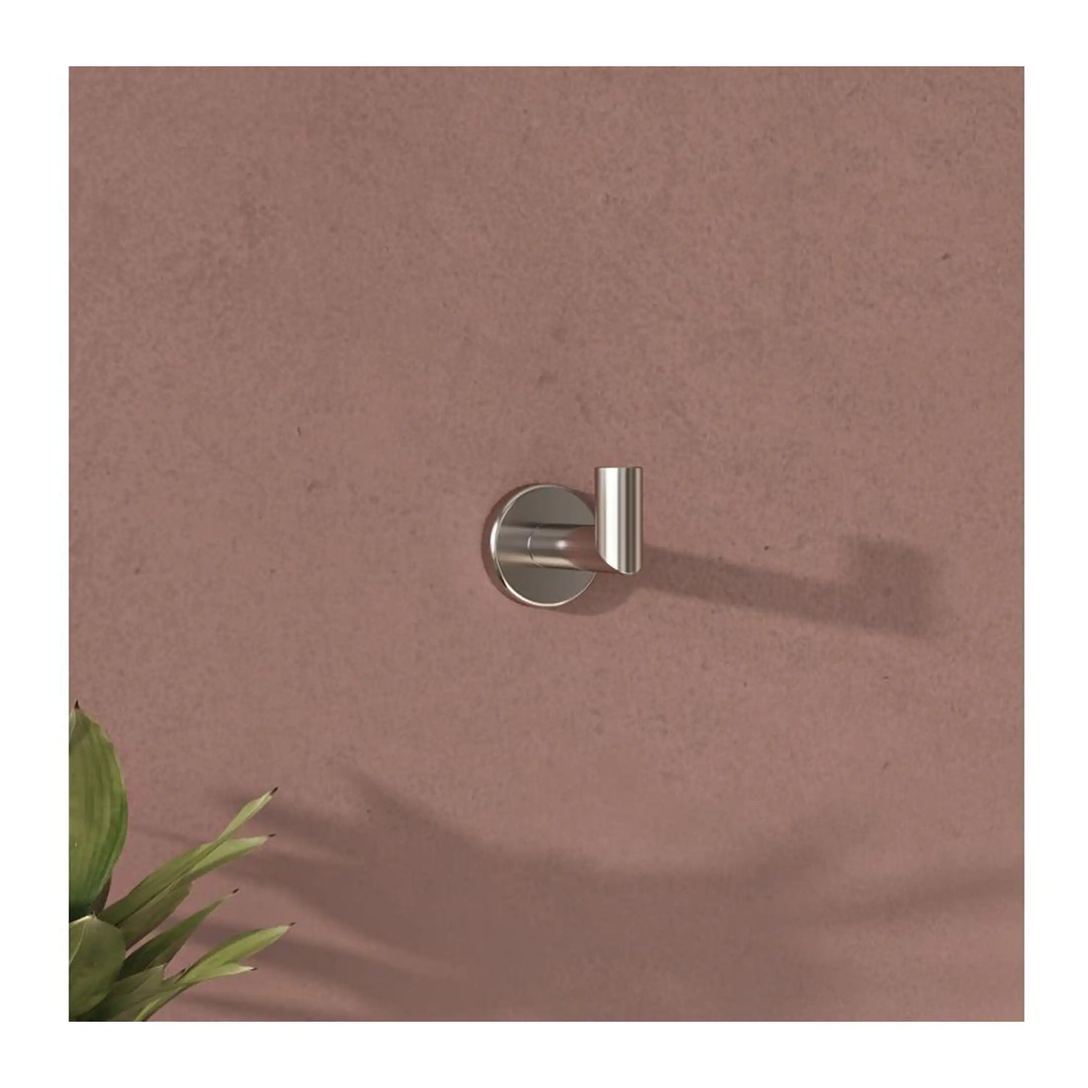 Sleek stainless steel towel hook mounted on a soft pink bathroom wall, ideal for modern bathroom organisation and storage.