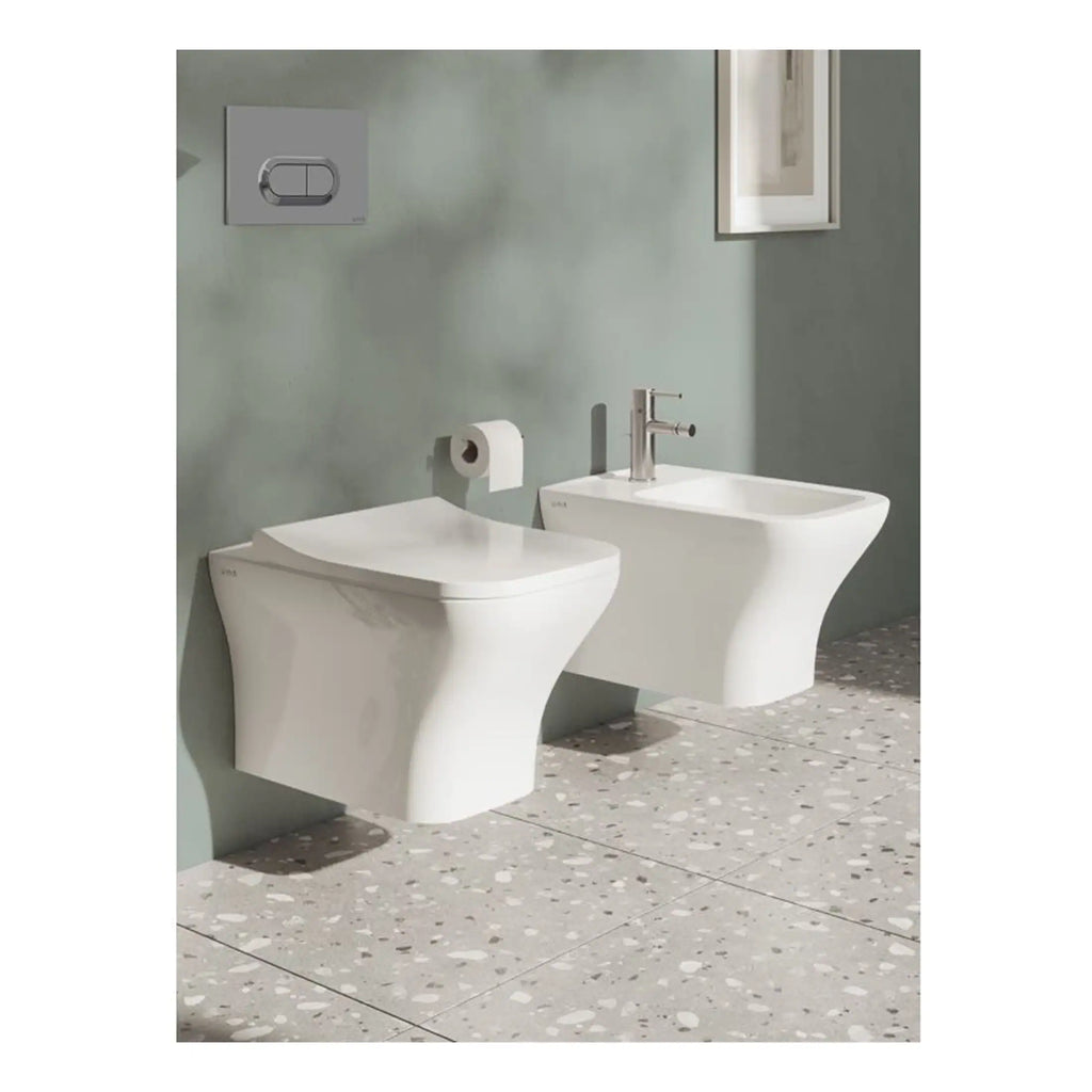 Sleek white bidet and toilet with modern design in a contemporary bathroom setting, featuring minimalist fixtures and terrazzo flooring, ideal for stylish bathroom renovations.