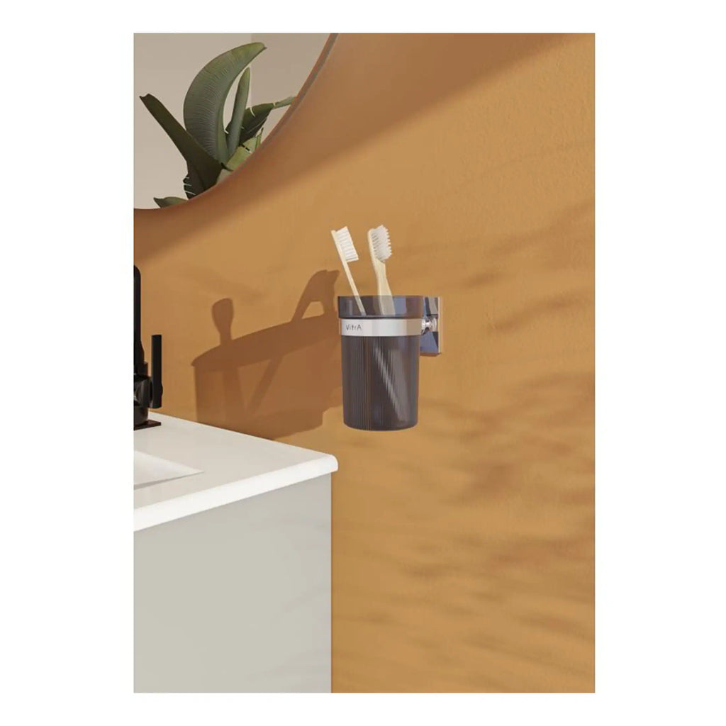 Toothbrush holder with two toothbrushes mounted on a beige wall in a modern bathroom setting.