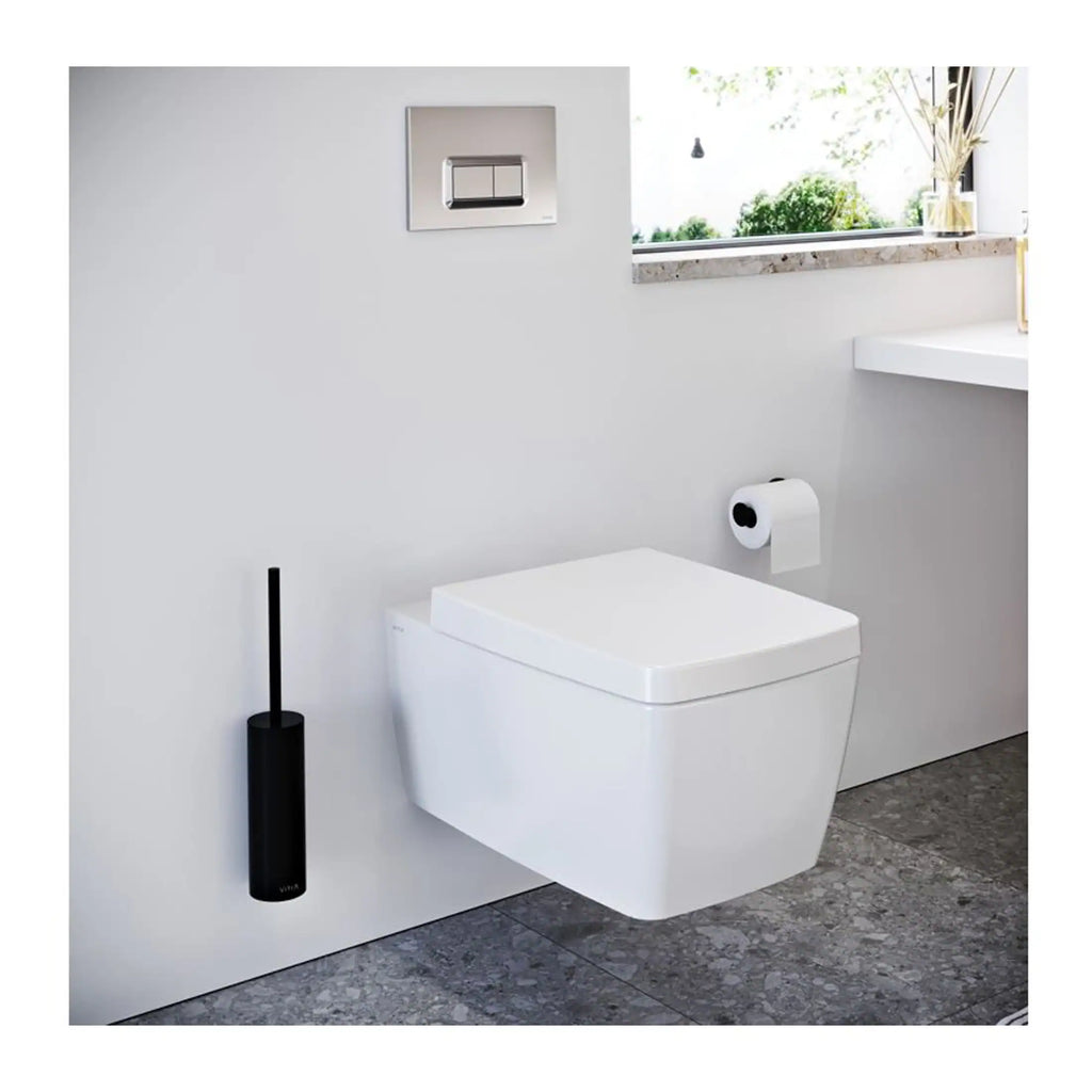 Sleek modern wall-mounted toilet in a contemporary bathroom with minimalist design and clean white fixtures. Natural light from the window highlights the stylish and functional bathroom setup.