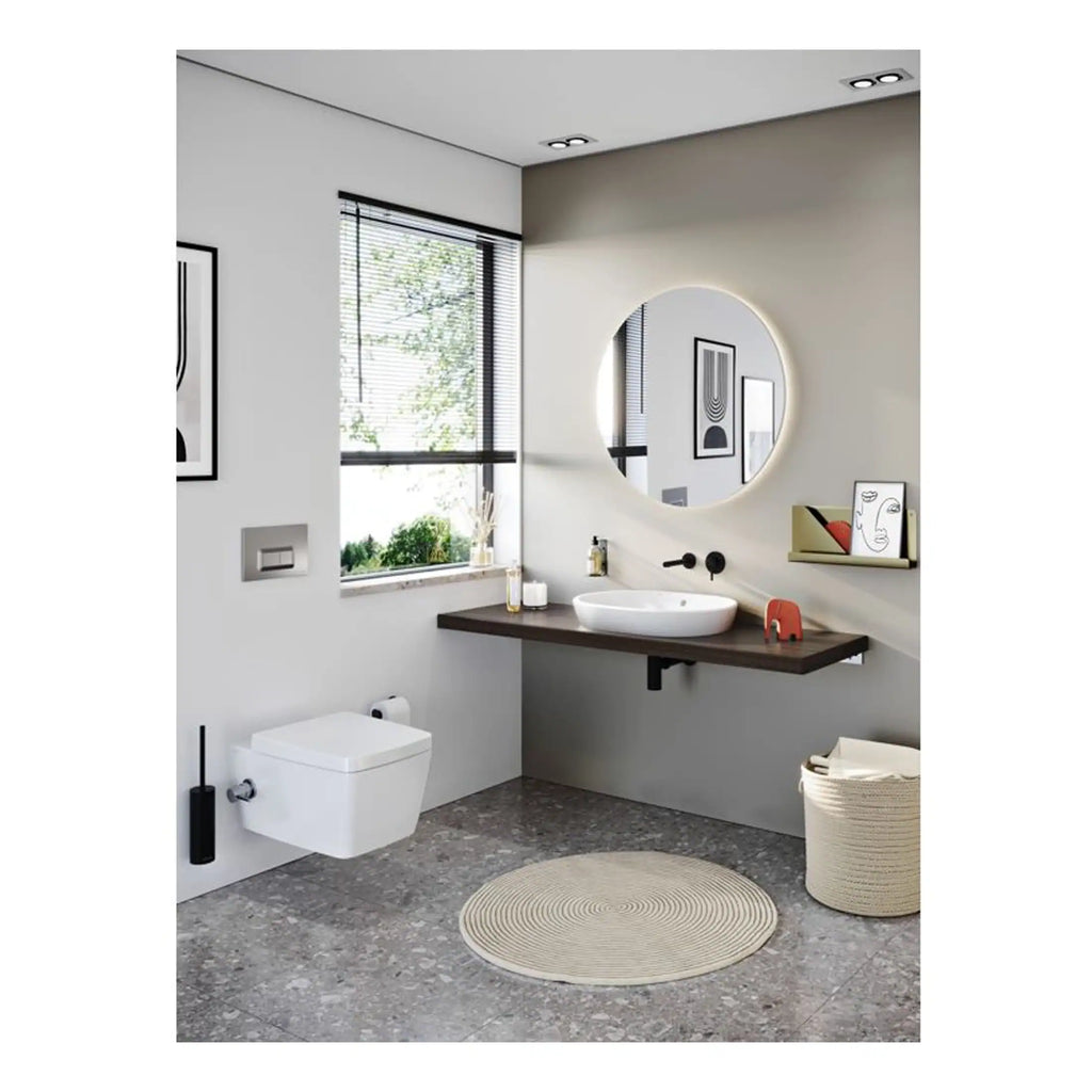 Modern minimalist bathroom with wall-mounted toilet, round mirror, floating vanity with vessel sink, and large window; stylish and functional bathroom design.